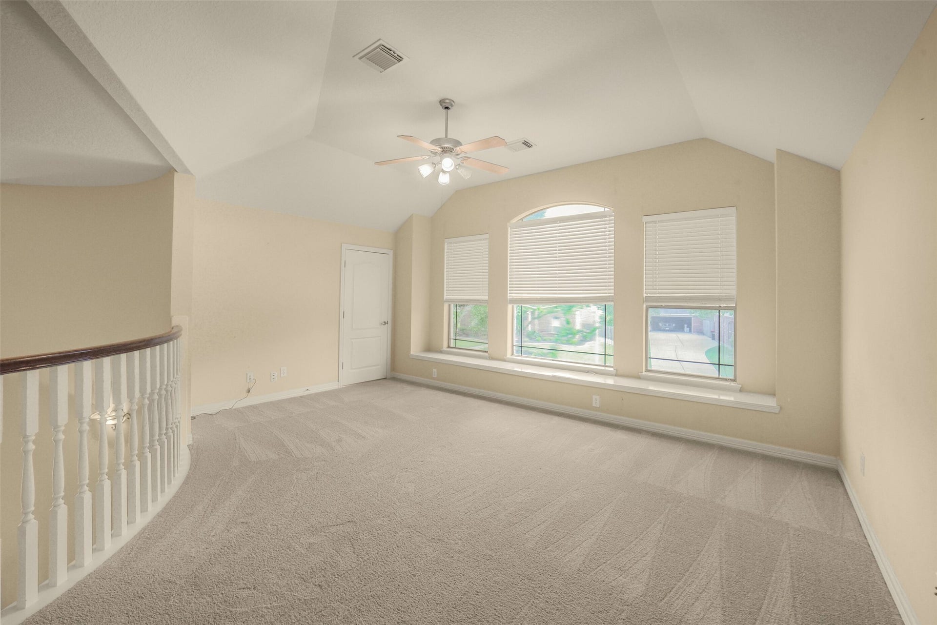 21603 Statfield Glen, Katy, TX 77450 The upstairs game room features charming gambrel ceilings and is equipped with a ceiling fan that includes a light fixture.