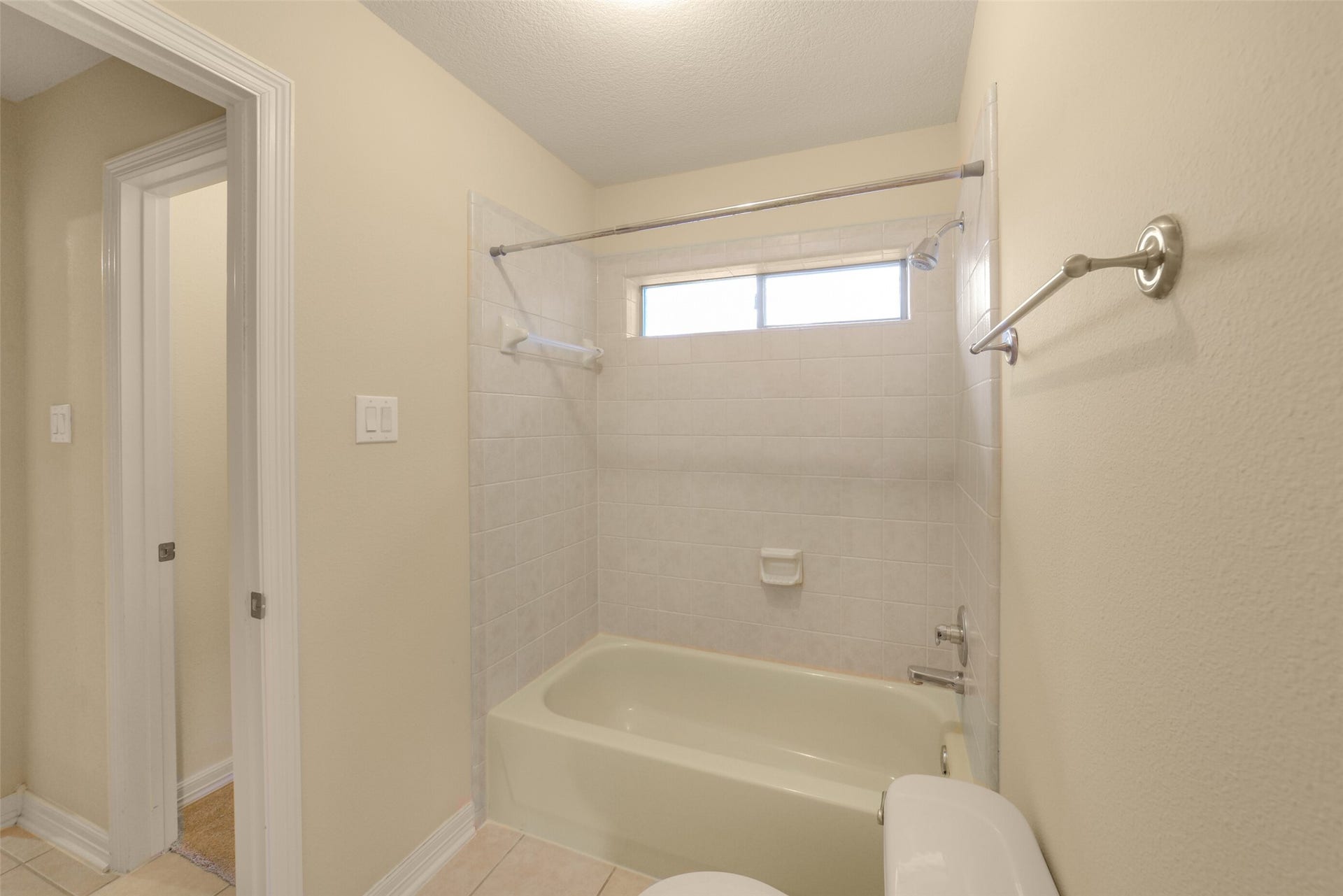 21603 Statfield Glen, Katy, TX 77450 Upstairs bathroom features a tub and shower with ceramic tile.