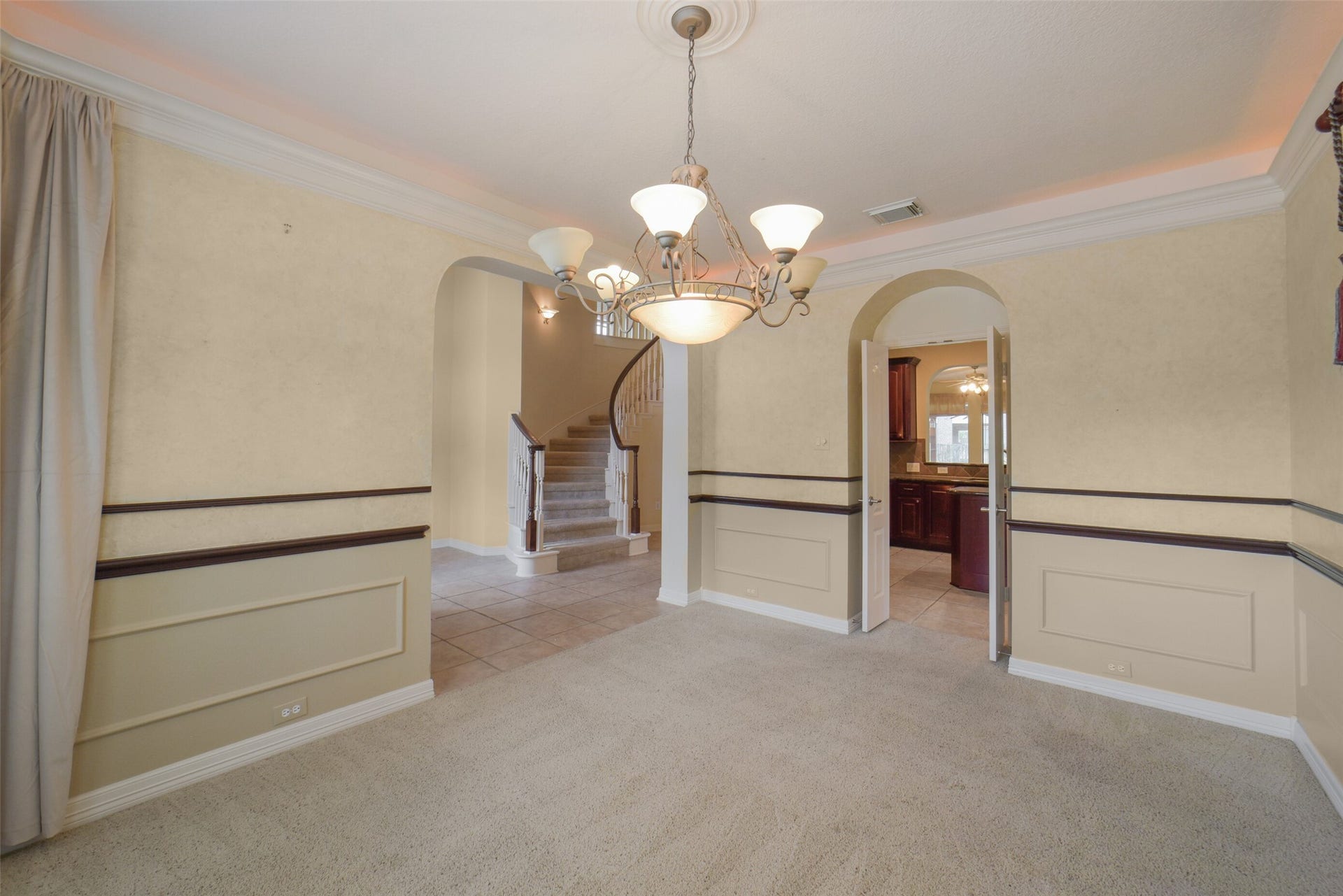 21603 Statfield Glen, Katy, TX 77450 The dining room features arched entries leading to the foyer and kitchen.