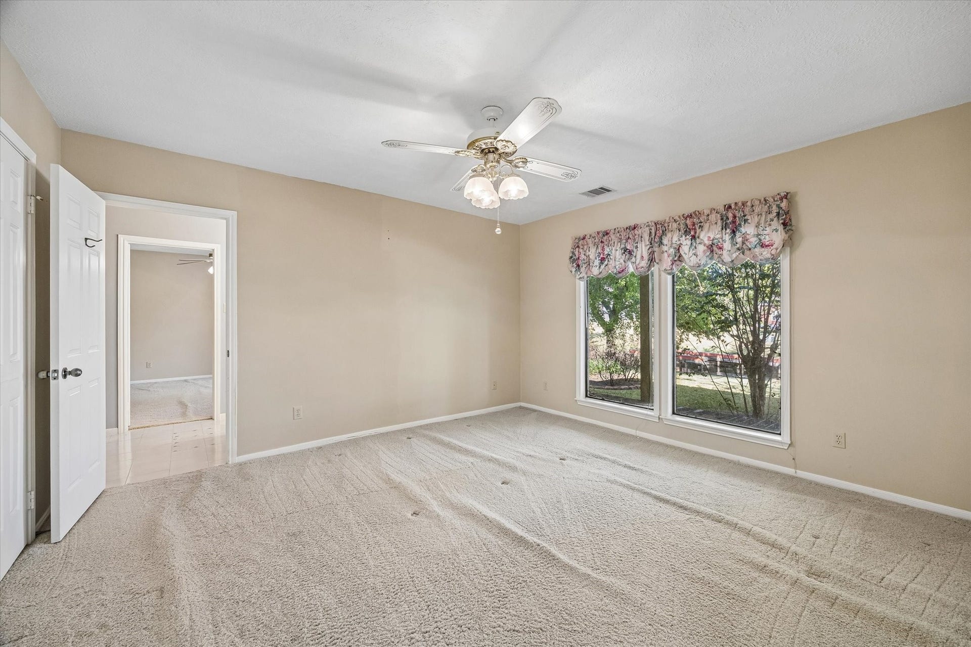 Spacious secondary bedroom offers plenty of room for furnishings and personal touches.