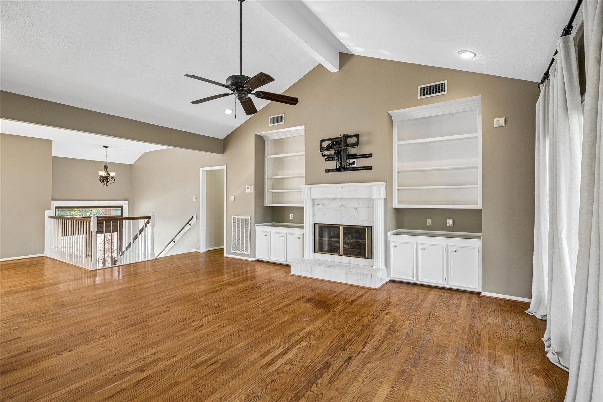 The spacious upstairs living room offers plenty of room to gather, with an open layout connecting the surrounding living spaces.