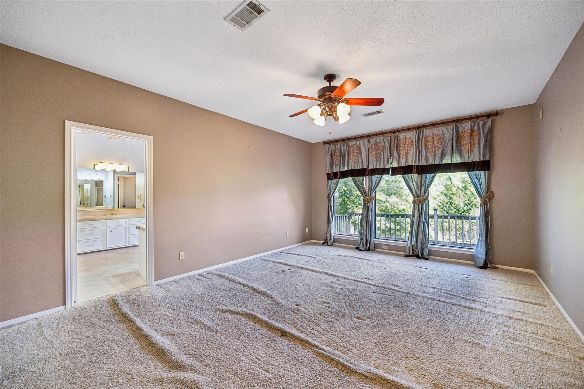 Upstairs primary bedroom enjoys peaceful water views and plenty of space for a comfortable sitting area.