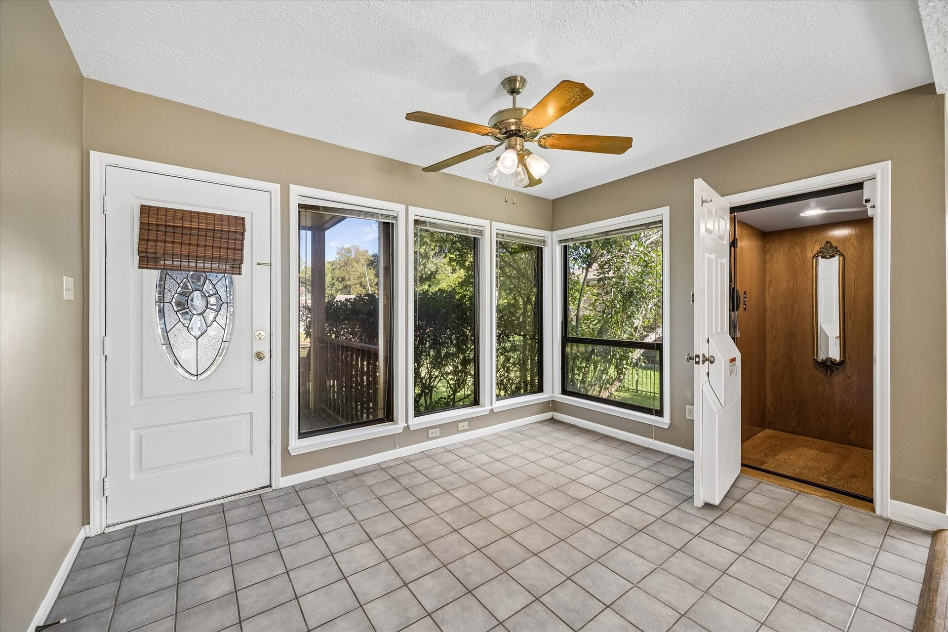 The elevator opens directly into the spacious downstairs game room, which also offers access to the backyard, covered deck and boathouse.