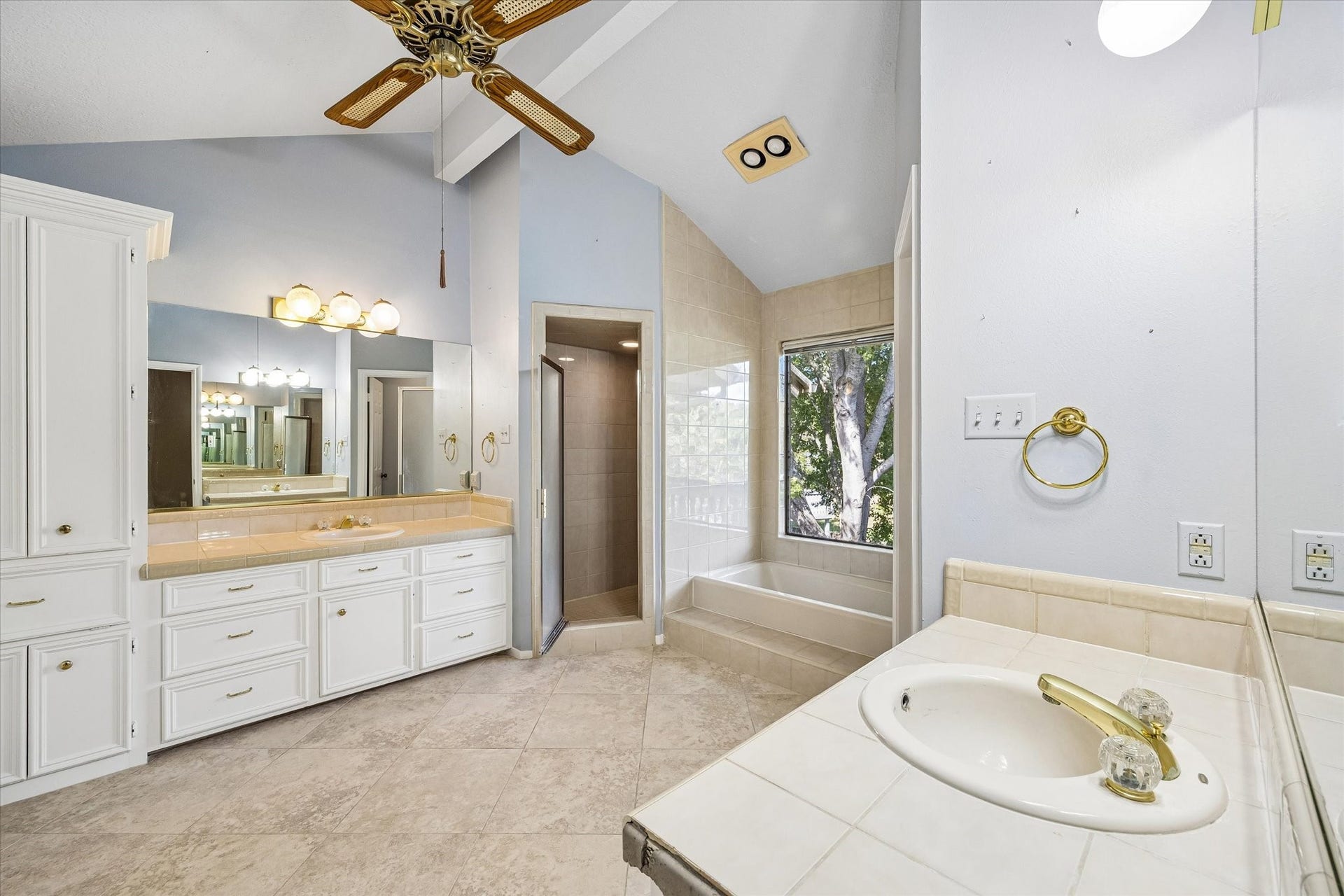 Spacious primary bath features dual vanities, abundant cabinetry and generous counter space.