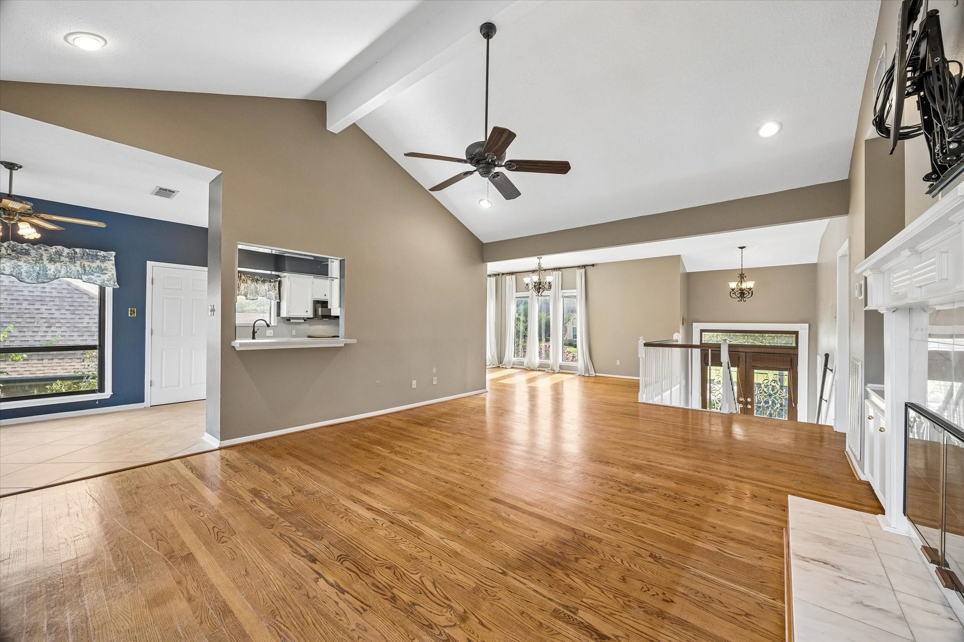 Upstairs living room features warm wood floors, a fireplace and abundant natural light.