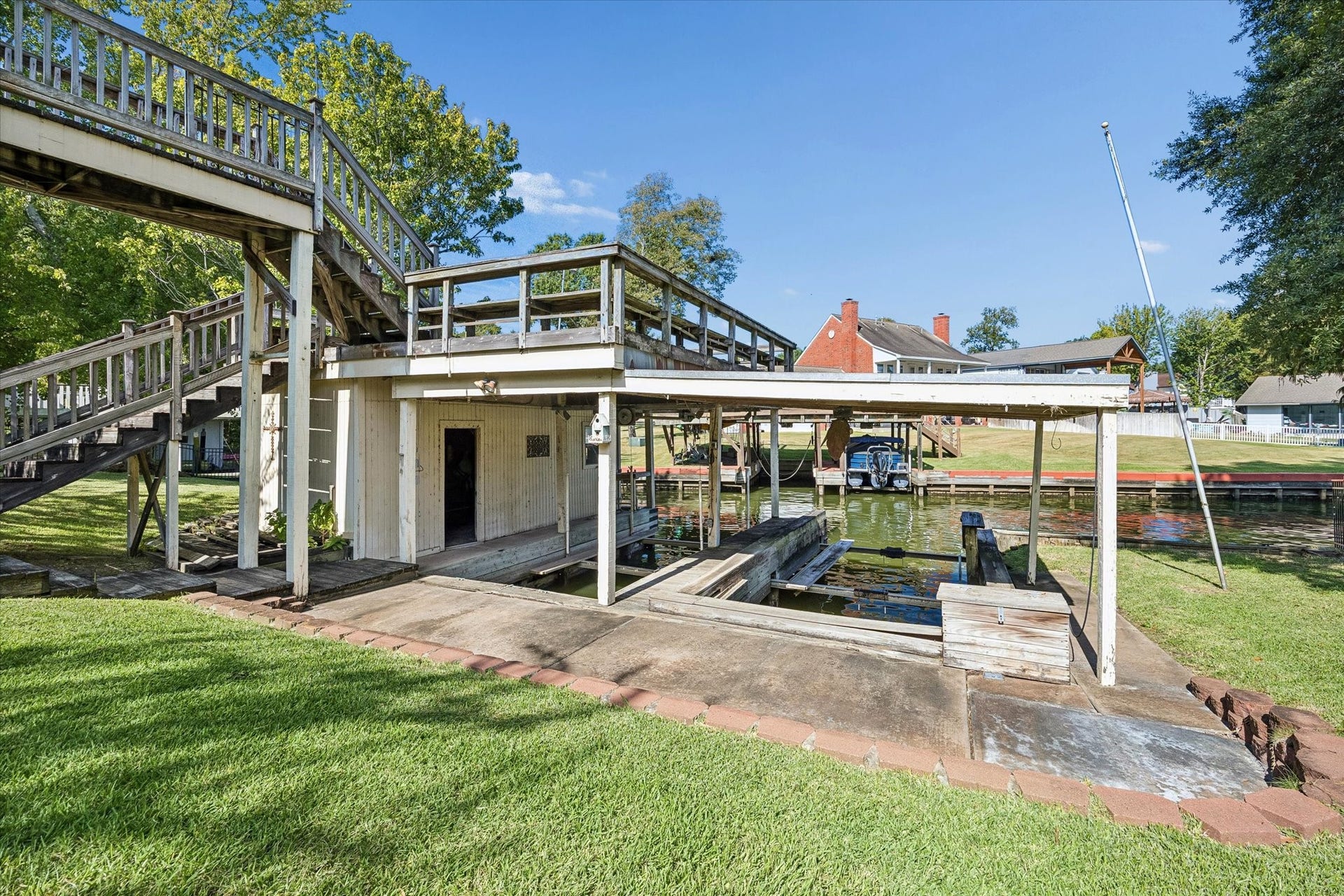 Imagine the possibilities! The boathouse features two boat lifts and a rooftop deck with the potential to become an incredible waterfront entertaining space when rebuilt.