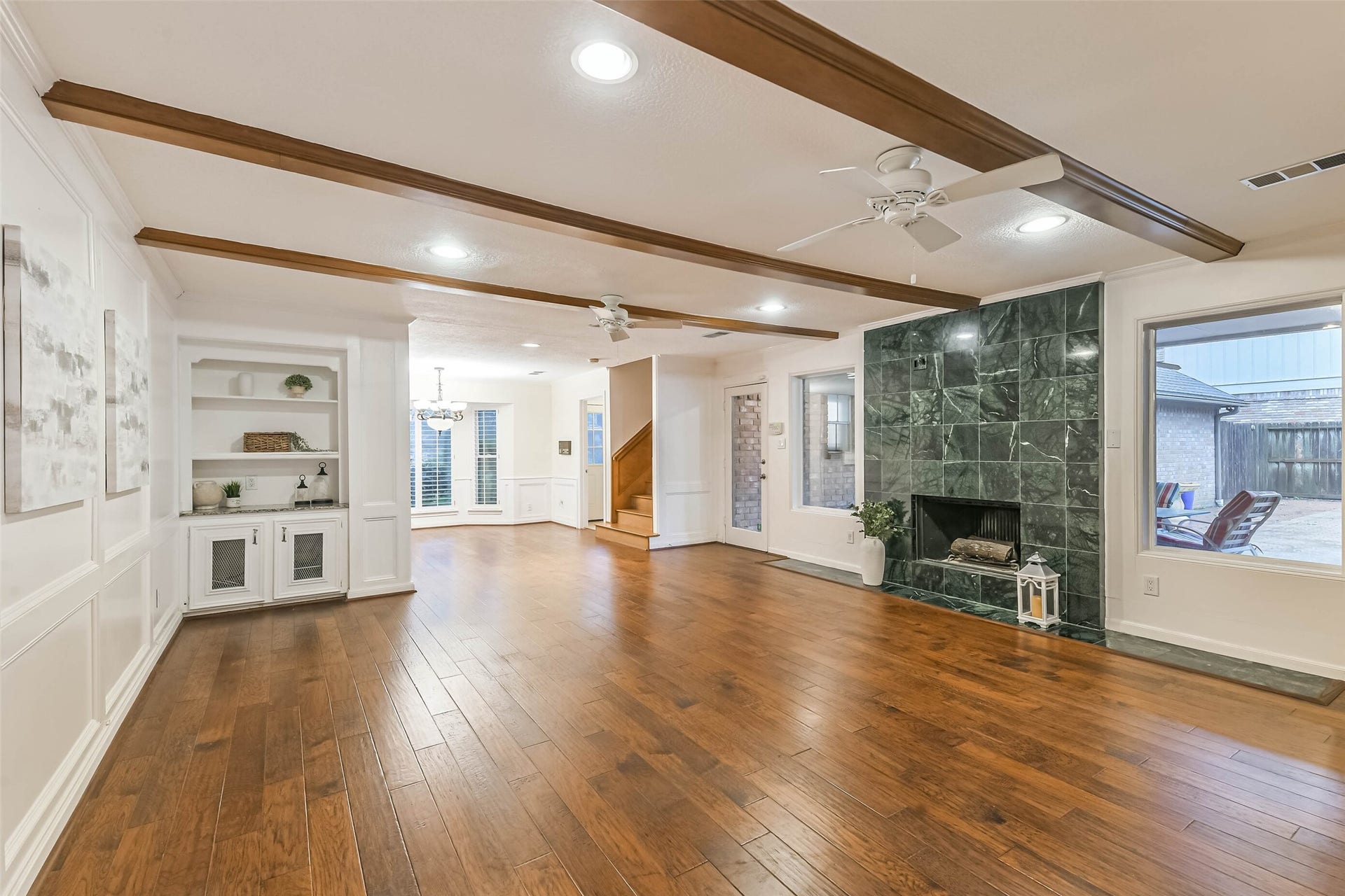 Spacious open living room with views out to the pool.