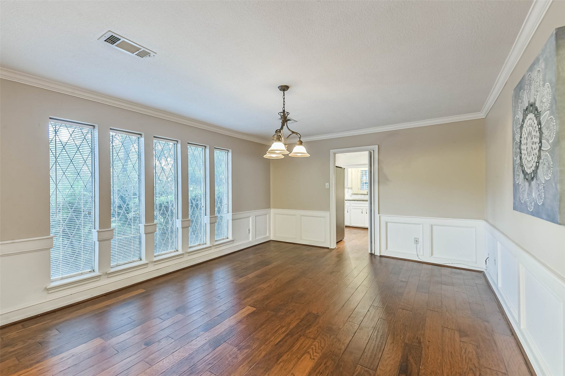 Large dining room just off the entryway with kitchen door access.