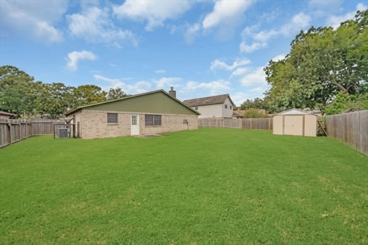 1707 Stone Lake Drive, Missouri City, TX 77489 Another view of the oversized fenced backyard featuring plenty of open lawn space and a storage shed.