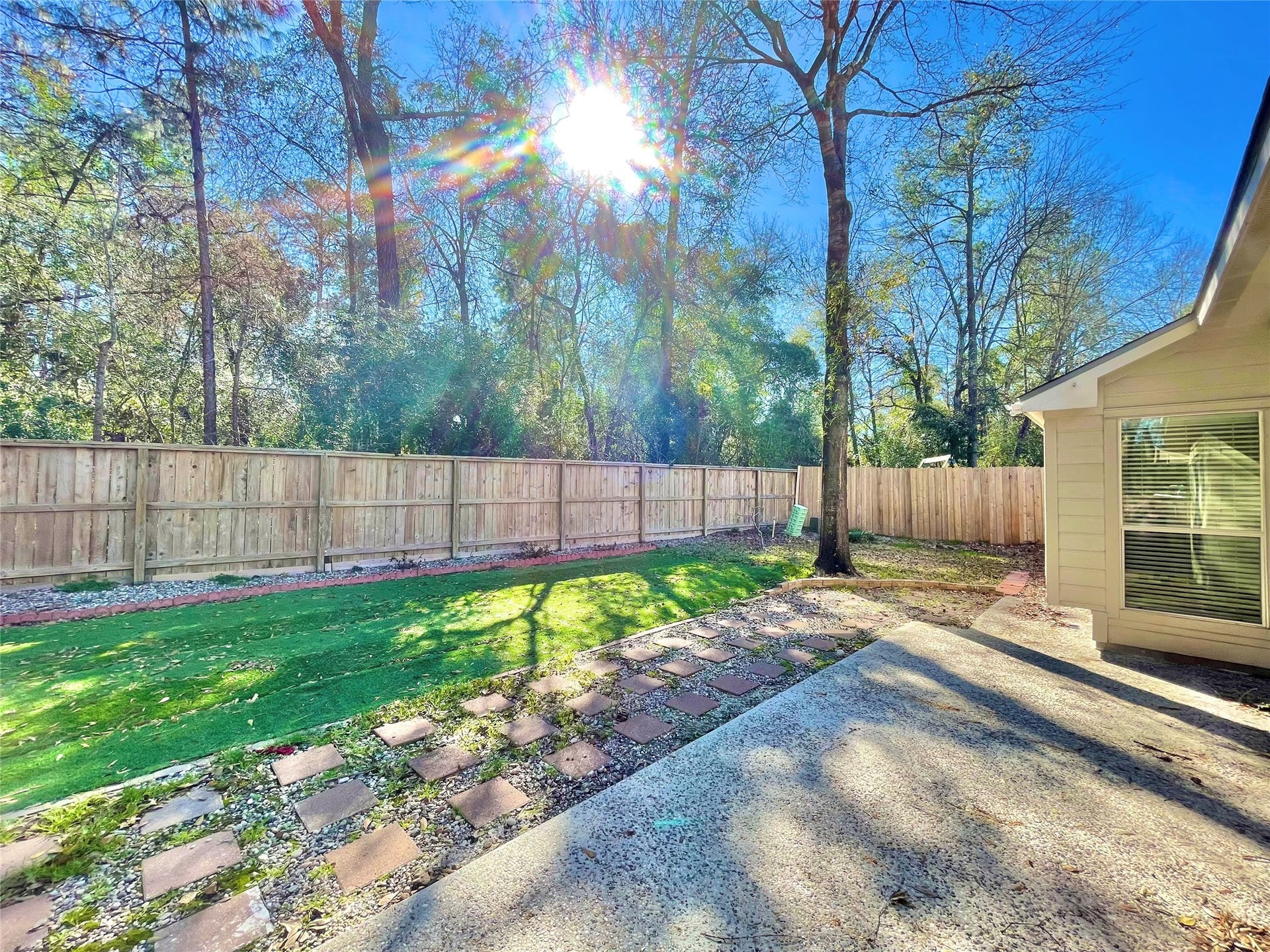 90 N Creekmist Place, The Woodlands, TX 77385 Low maintenance yard backs to a greenbelt of trees.