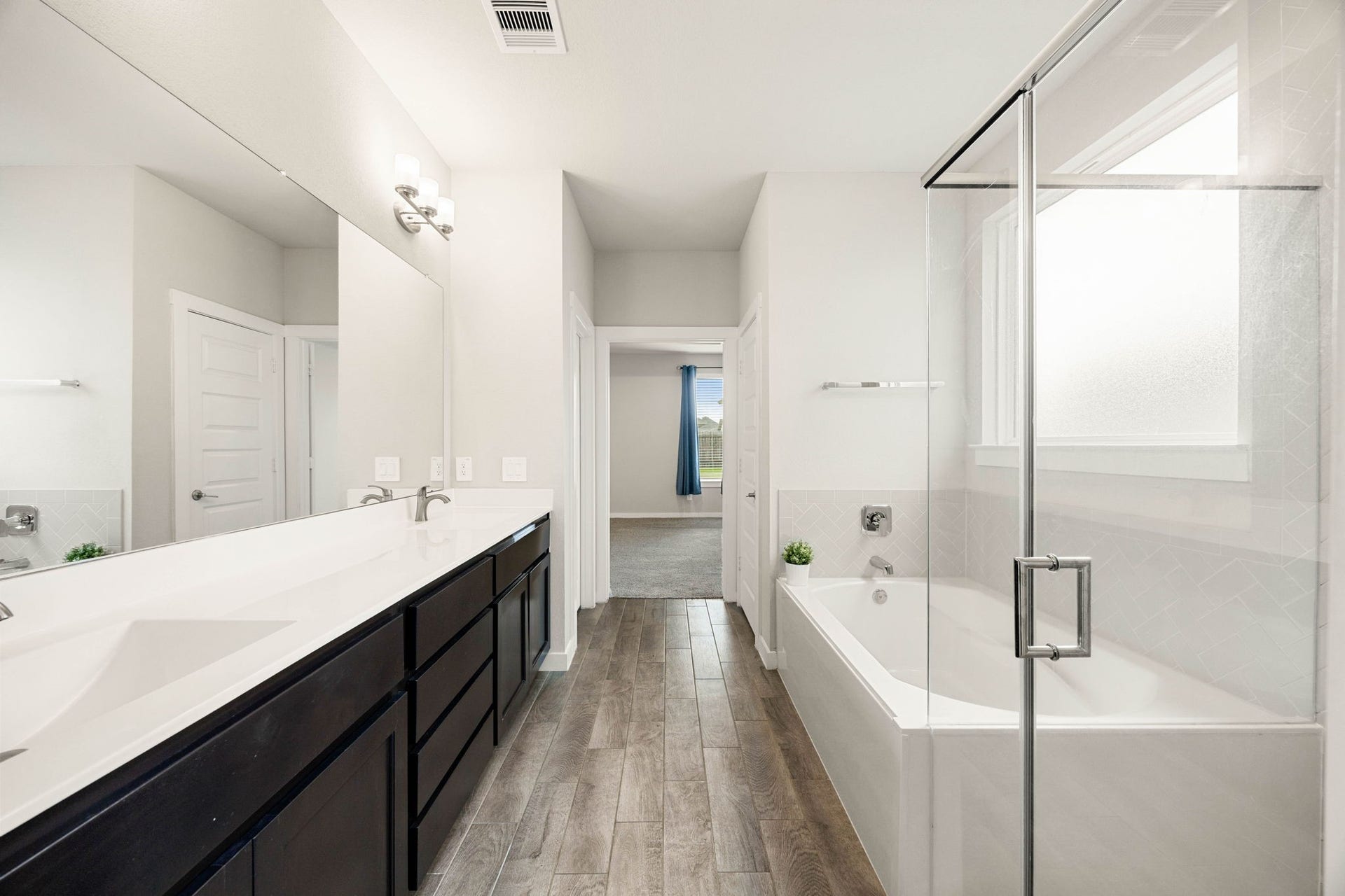 3815 Favor Forest Court, Katy, TX 77494 A double vanity with a generous quartz countertop and a large mirror gives the primary ensuite bath a spa-like, functional feel plenty of room for two to get ready at once.