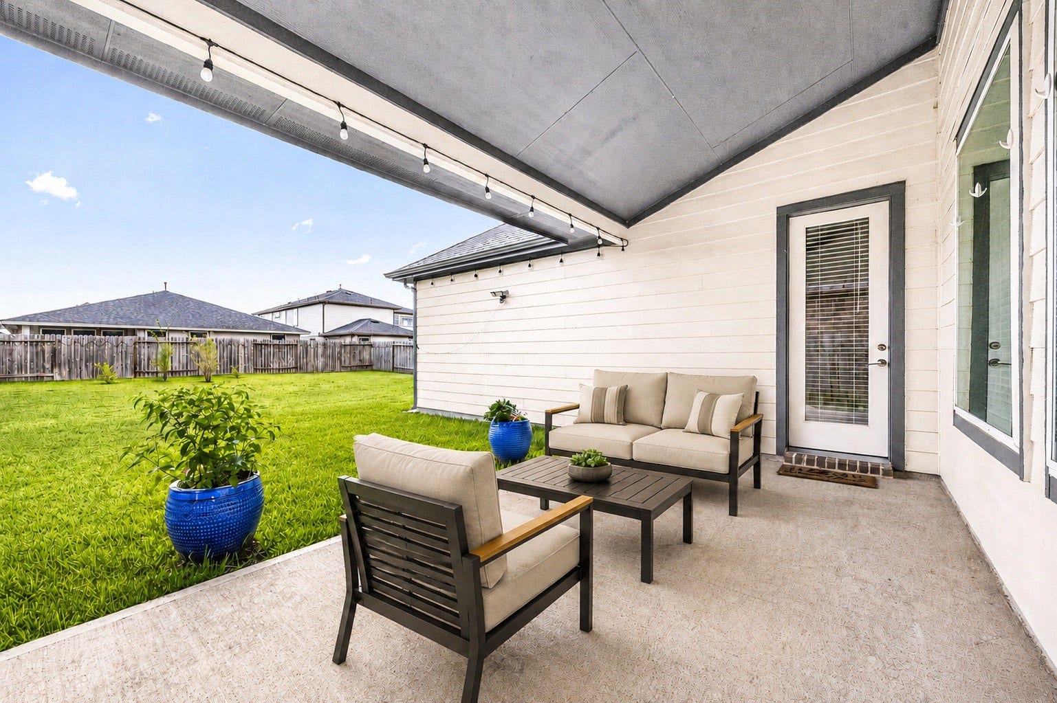 3815 Favor Forest Court, Katy, TX 77494 The covered patio offers a shaded outdoor space with string lighting, perfect for relaxing evenings or weekend gatherings. Virtually staged.
