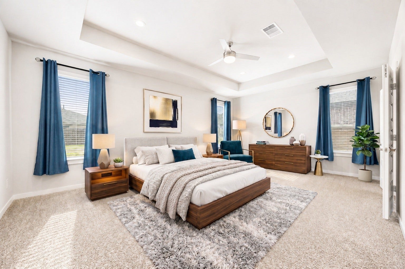 3815 Favor Forest Court, Katy, TX 77494 The primary bedroom is conveniently located on the first floor, featuring a tray ceiling, ceiling fan, and three windows for abundant natural light. Virtually staged.