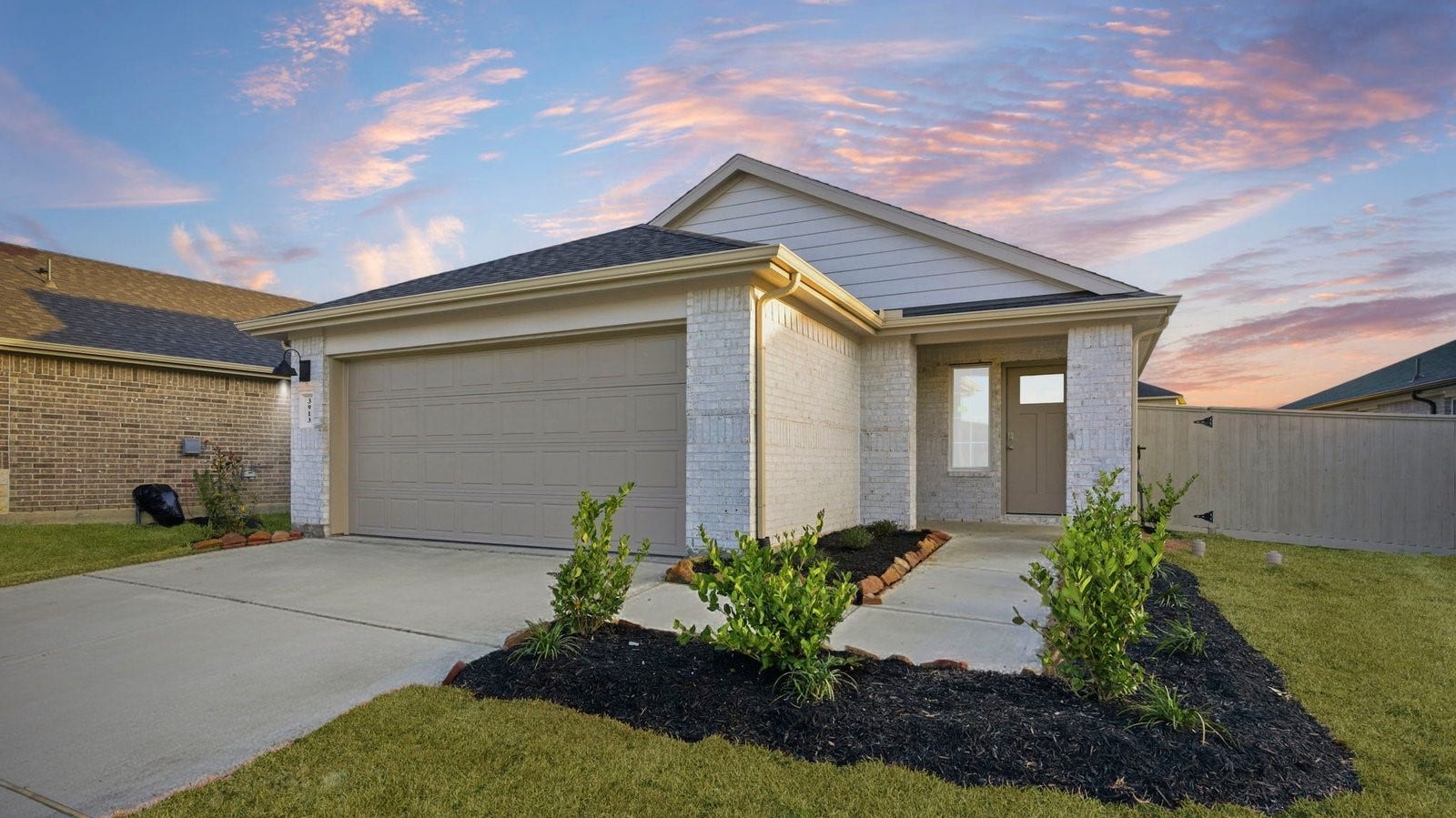 3545 Longhorn Valley Street, League City, TX 77511 Newly built single story home with traditional architecture, a double garage, and landscaped front yard.