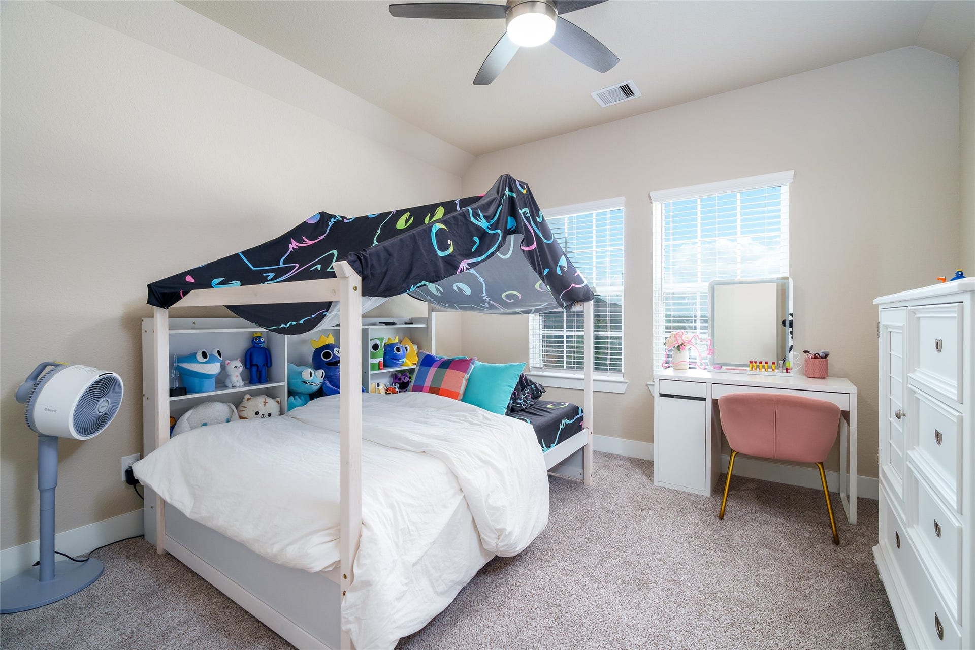 3348 Voda Bend Drive, Katy, TX 77493 This inviting bedroom features plush carpet, windows for natural light, and a sleek modern ceiling fan for added comfort.