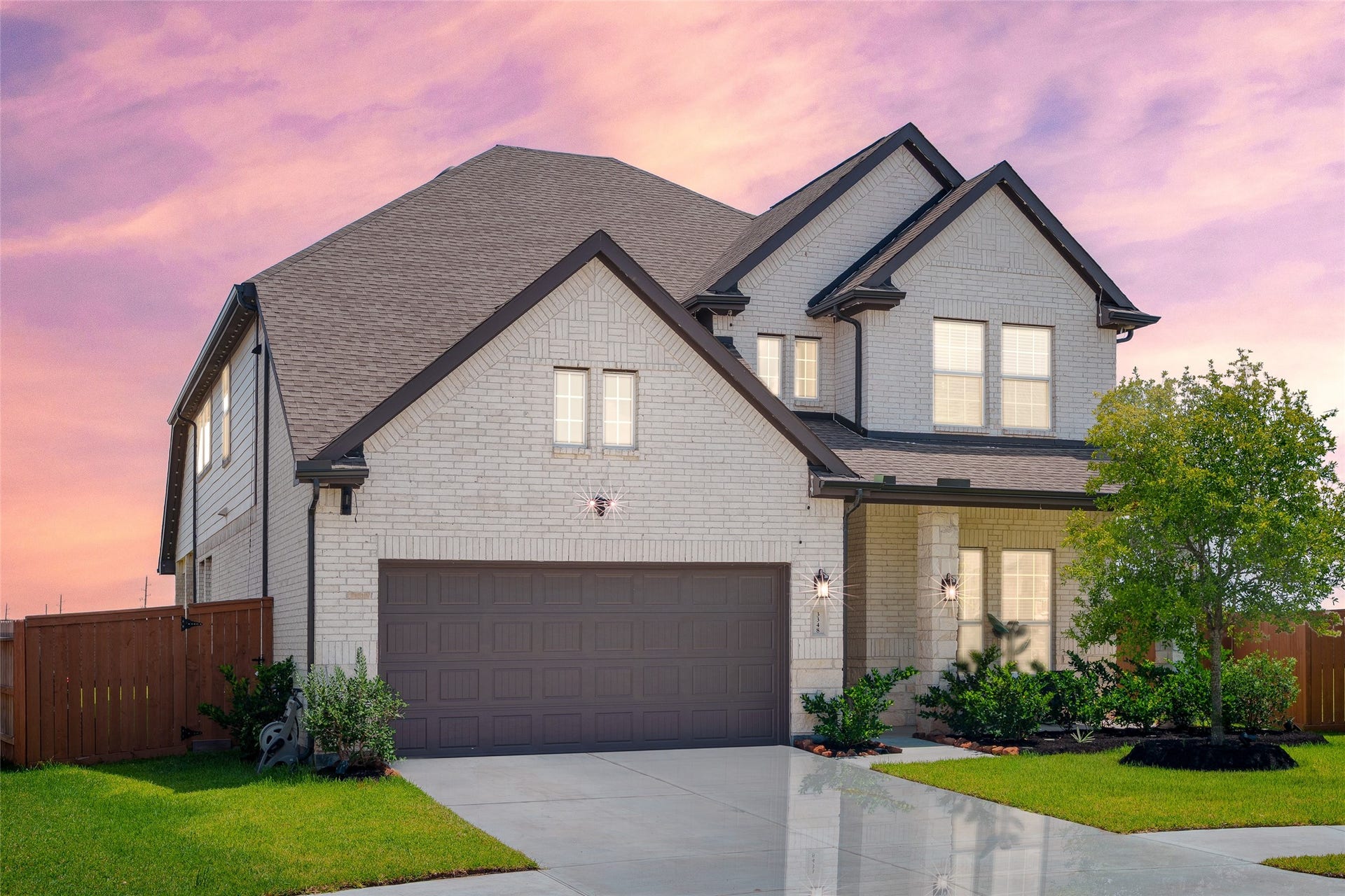 3348 Voda Bend Drive, Katy, TX 77493 Enjoy outdoor living on the front patio, beautifully complemented by an upgraded stone/brick elevation, full gutters, plush landscaping, and a well maintained front lawn.