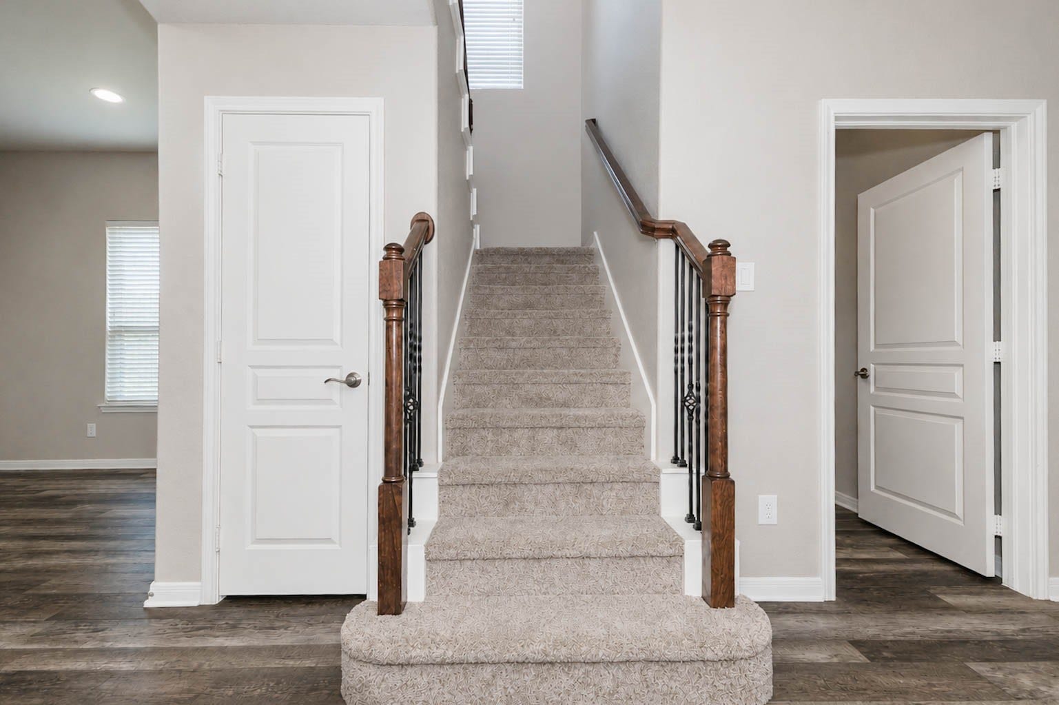 30218 Creekside Drive, Brookshire, TX 77423 Elegant staircase with new, plush carpeting and wooden handrails, leading to the second floor.