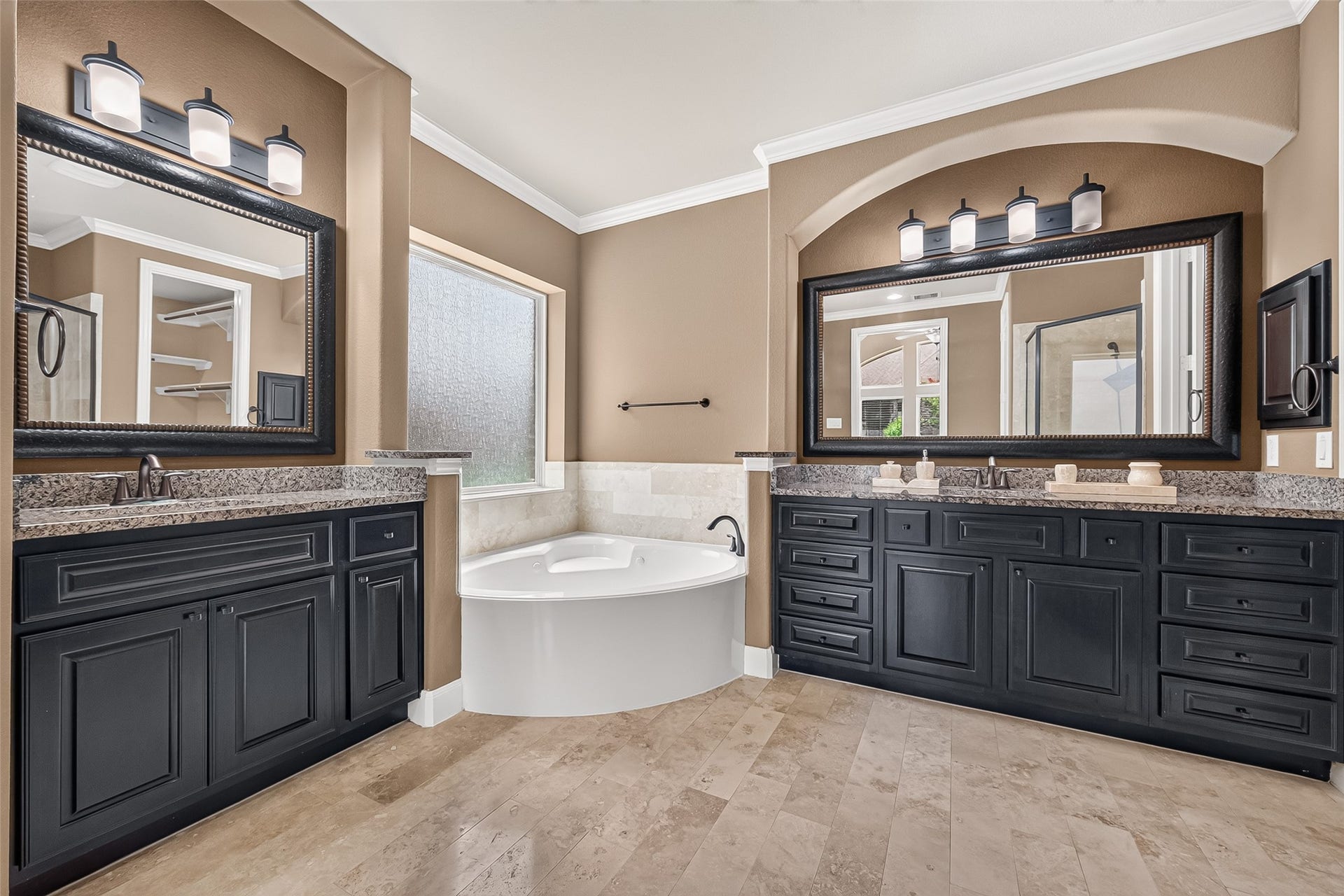 27818 Tamara Branch Lane, Katy, TX 77494 Primary Ensuite: Double doors lead into the spa-inspired primary bath featuring a corner soaking tub, separate shower, dual vanities, elegant cabinetry, and oversized vanity mirrors.