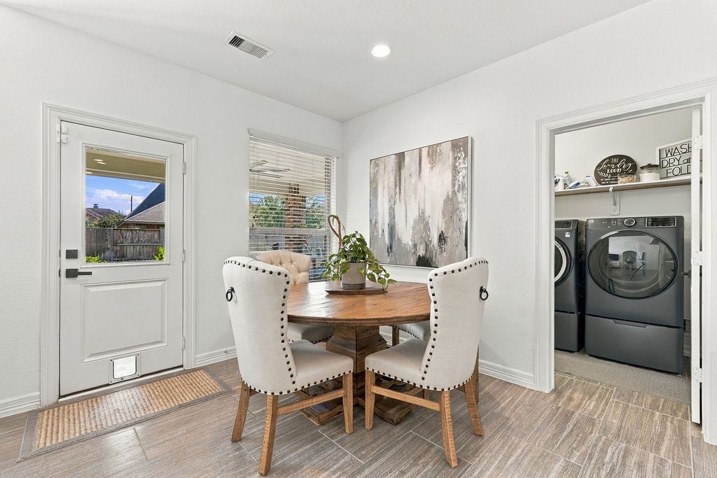 9918 Hubble Drive, Iowa Colony, TX 77583 Bright and inviting breakfast area, large window for natural light, and convenient access to a modern laundry room with high-efficiency washer and dryer.