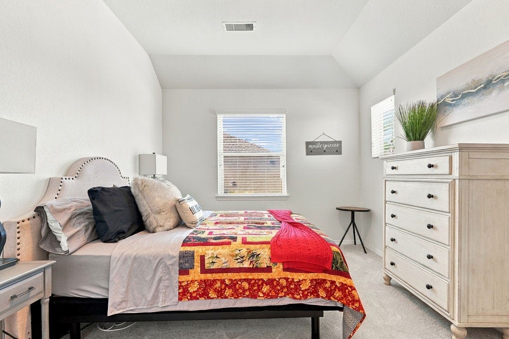 9918 Hubble Drive, Iowa Colony, TX 77583 Bedroom 2- Upstairs w/ walk-in closet and attic access door.