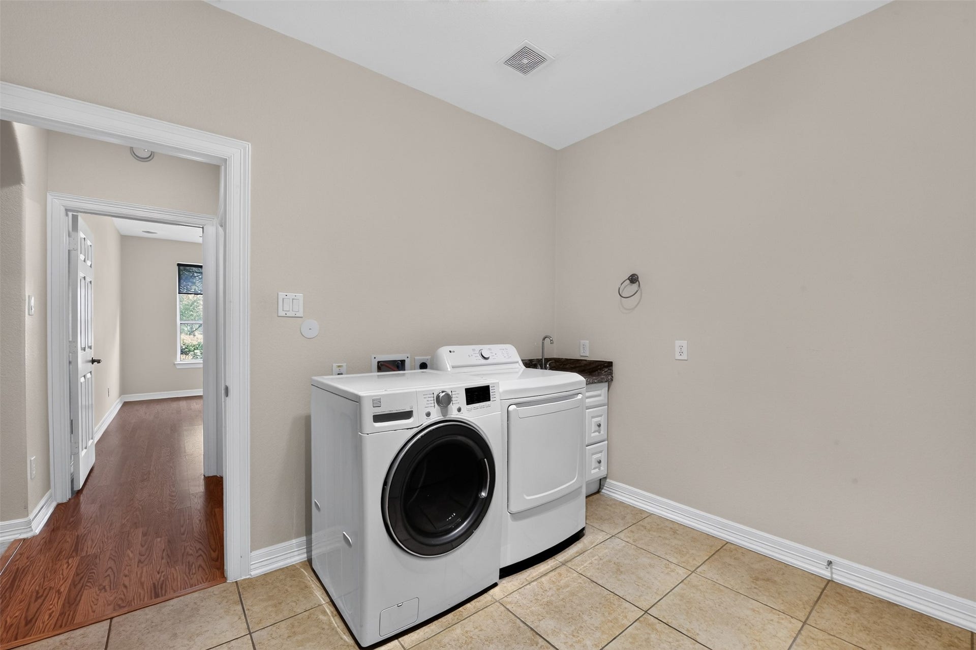 12009 Cedar Creek Drive, Pearland, TX 77584 Large utility room! Tile flooring and convenient sink area. A perfect mud room! The front load washer & dryer stay with home. Built-in shelving and cabinets. Storage closet with double doors. (Connections for both gas/electric dryer.)