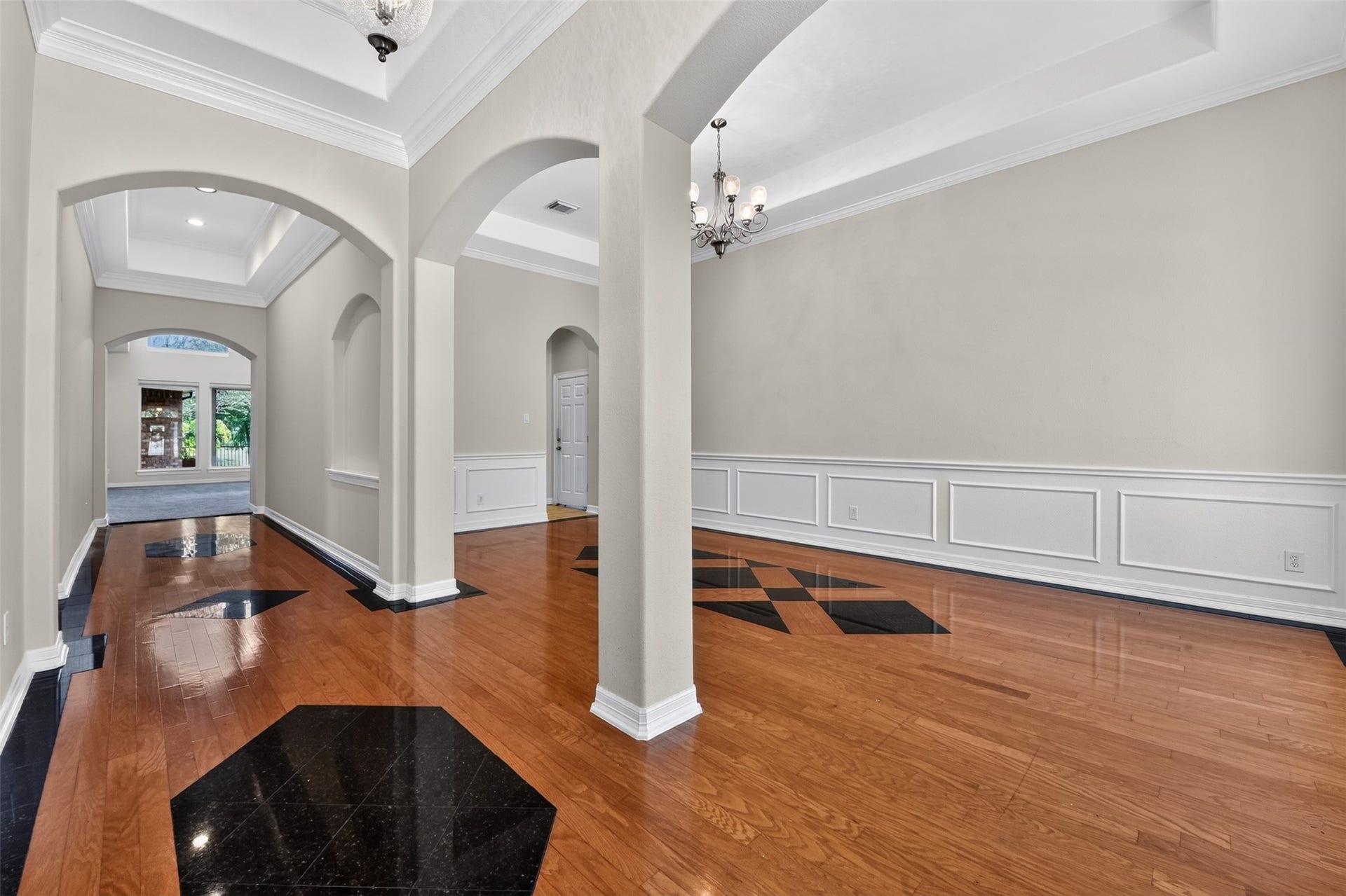 12009 Cedar Creek Drive, Pearland, TX 77584 Granite accent inserts with hardwood flooring. Tray ceilings, moldings and updated lighting! Arches invite you into the grand formal dining room.