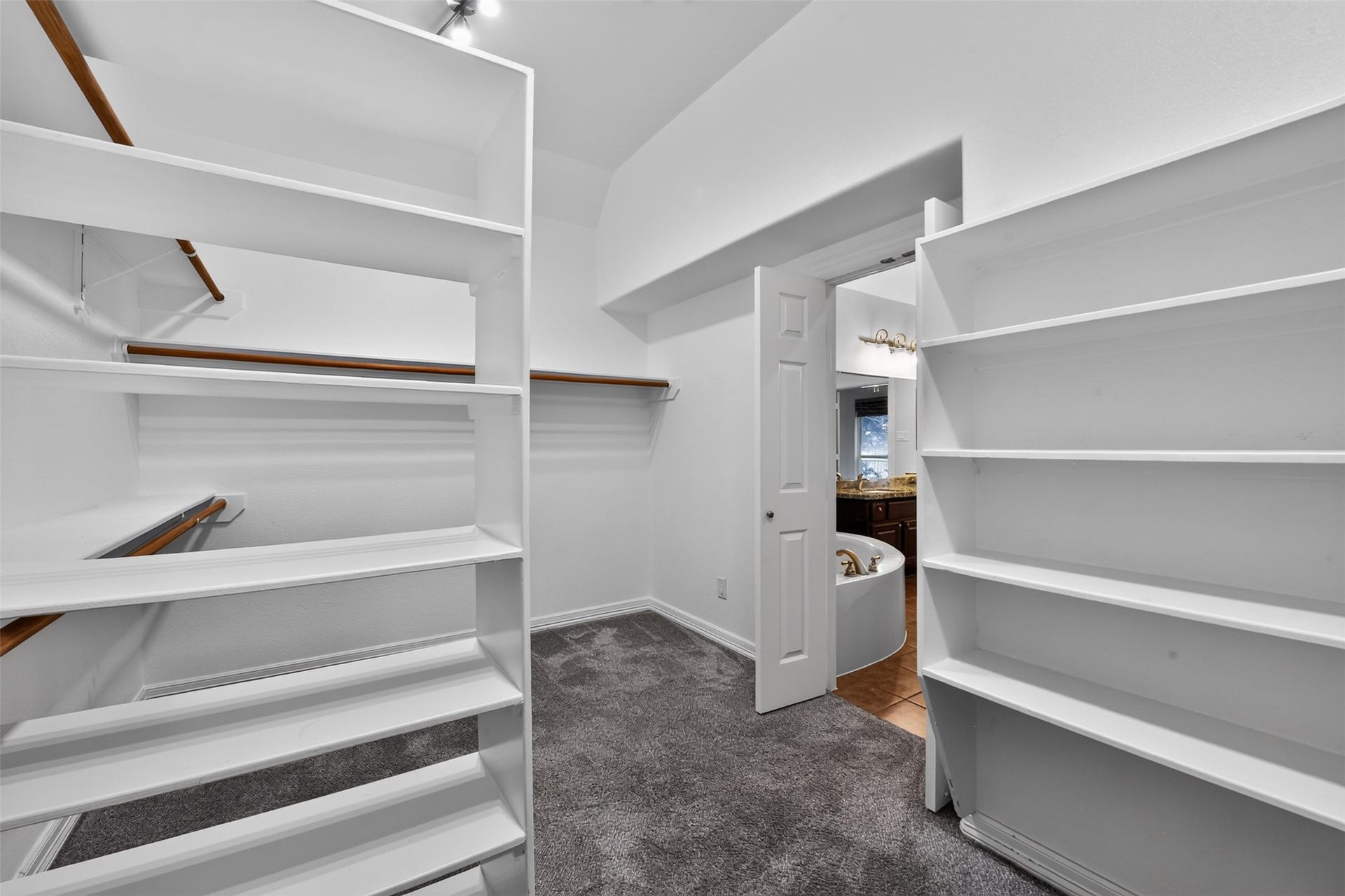 12009 Cedar Creek Drive, Pearland, TX 77584 The large primary walk-in closet.