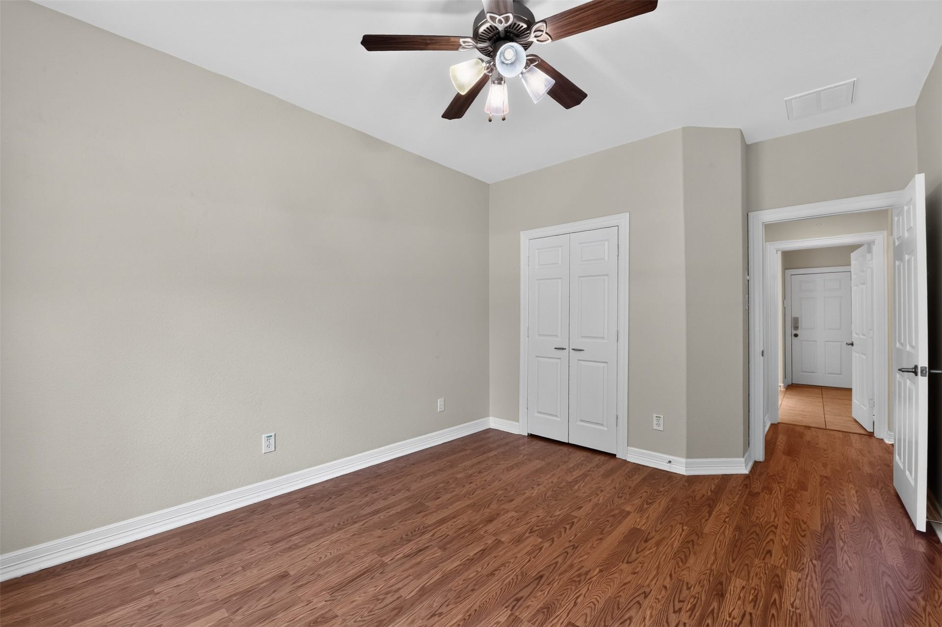 12009 Cedar Creek Drive, Pearland, TX 77584 This secondary bedroom (2nd) offers hardwood flooring, a great closet space and a lighted ceiling fan.