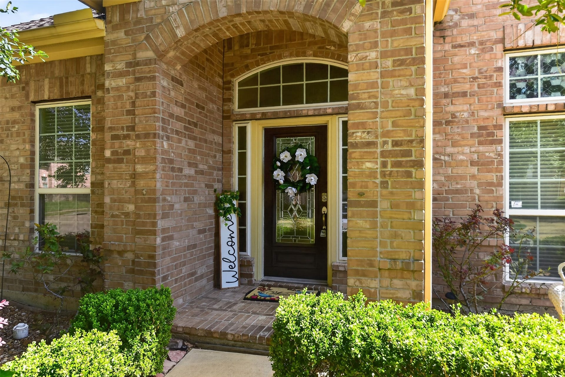 12009 Cedar Creek Drive, Pearland, TX 77584 Inviting covered front entrance with beautiful leaded glass door.