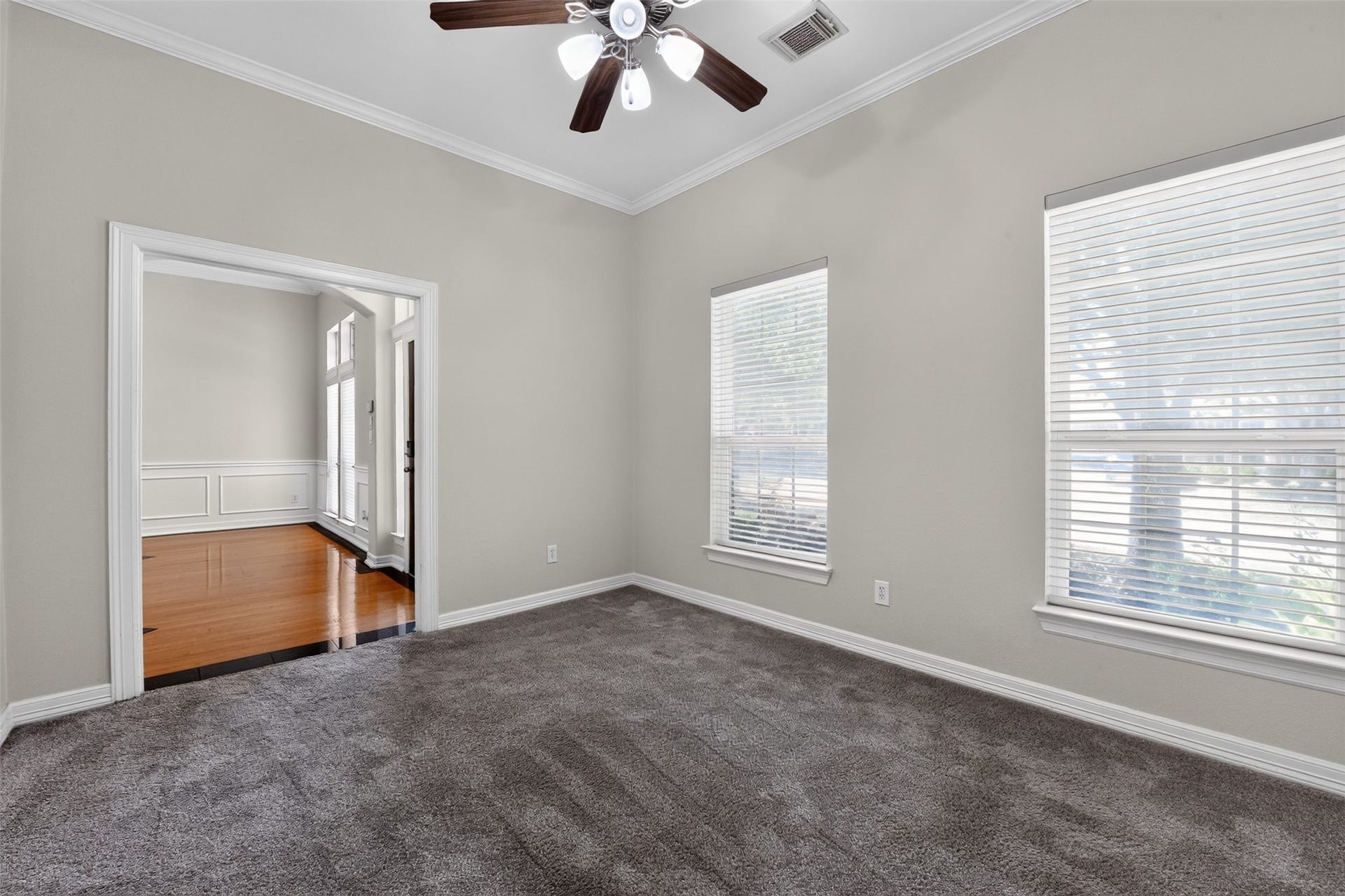 12009 Cedar Creek Drive, Pearland, TX 77584 The study has a speaker system and windows with 2" blinds facing the front yard. A large entry hallway storage closet located nearby.