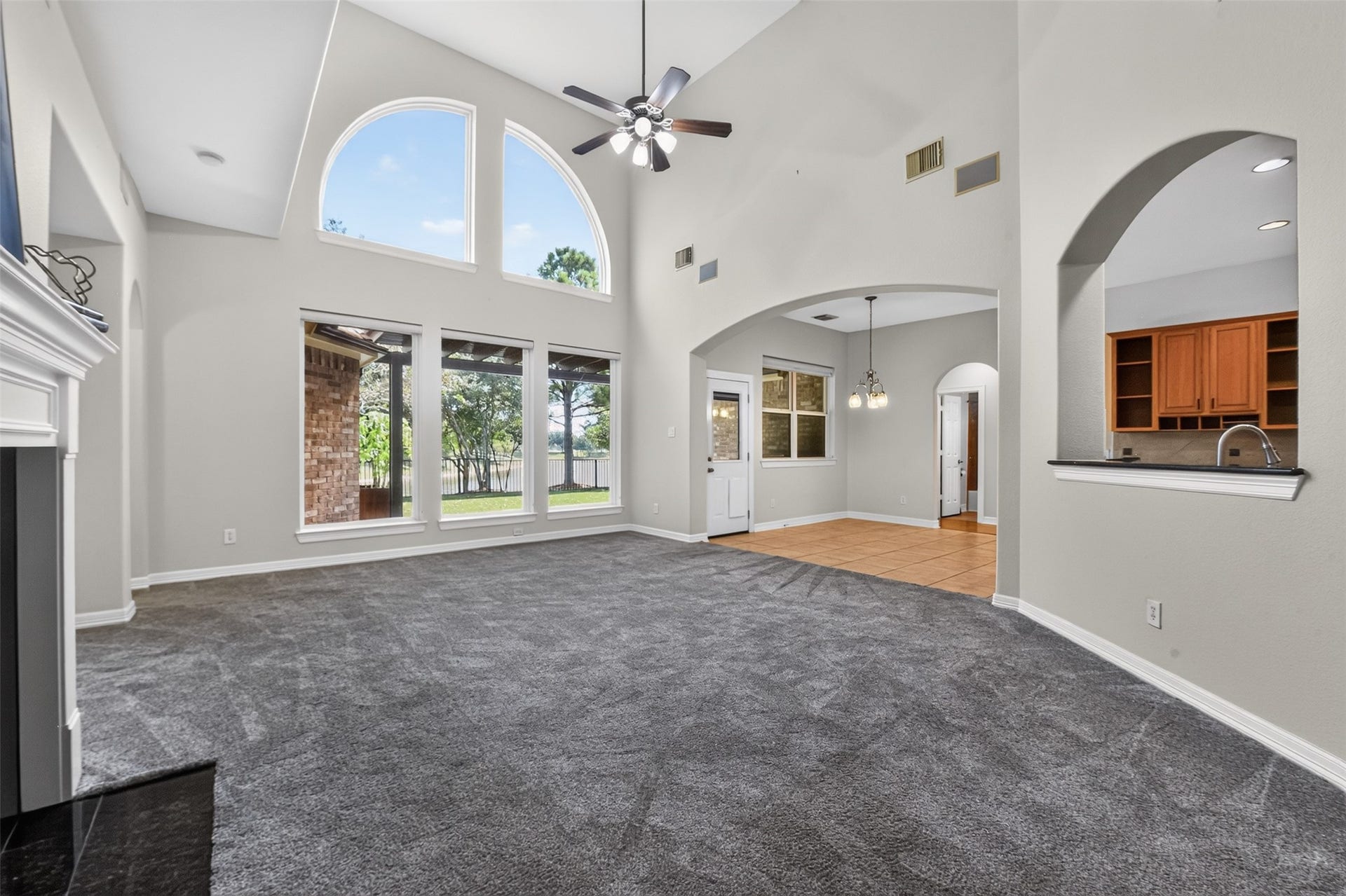 12009 Cedar Creek Drive, Pearland, TX 77584 Lighted ceiling fan and the room opens nicely to the kitchen and breakfast area.