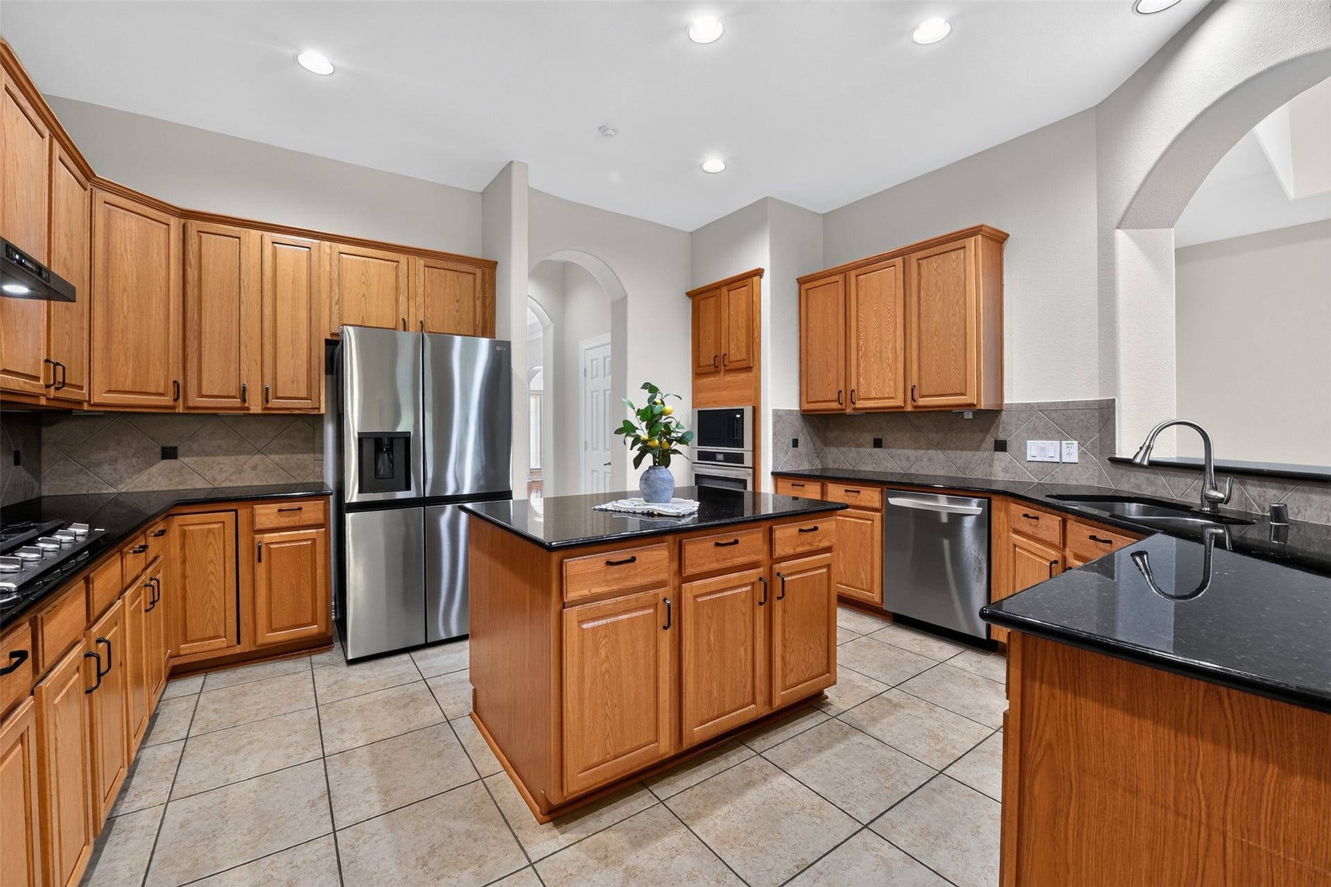 12009 Cedar Creek Drive, Pearland, TX 77584 Kitchen with all updated appliances: a Samsung 5 Burner Gas Cooktop, LG stainless steel French Door Refrigerator, Frigidaire stainless steel oven and microwave, LG stainless steel dishwasher, and a Hiso Hu Vent with Led lights!