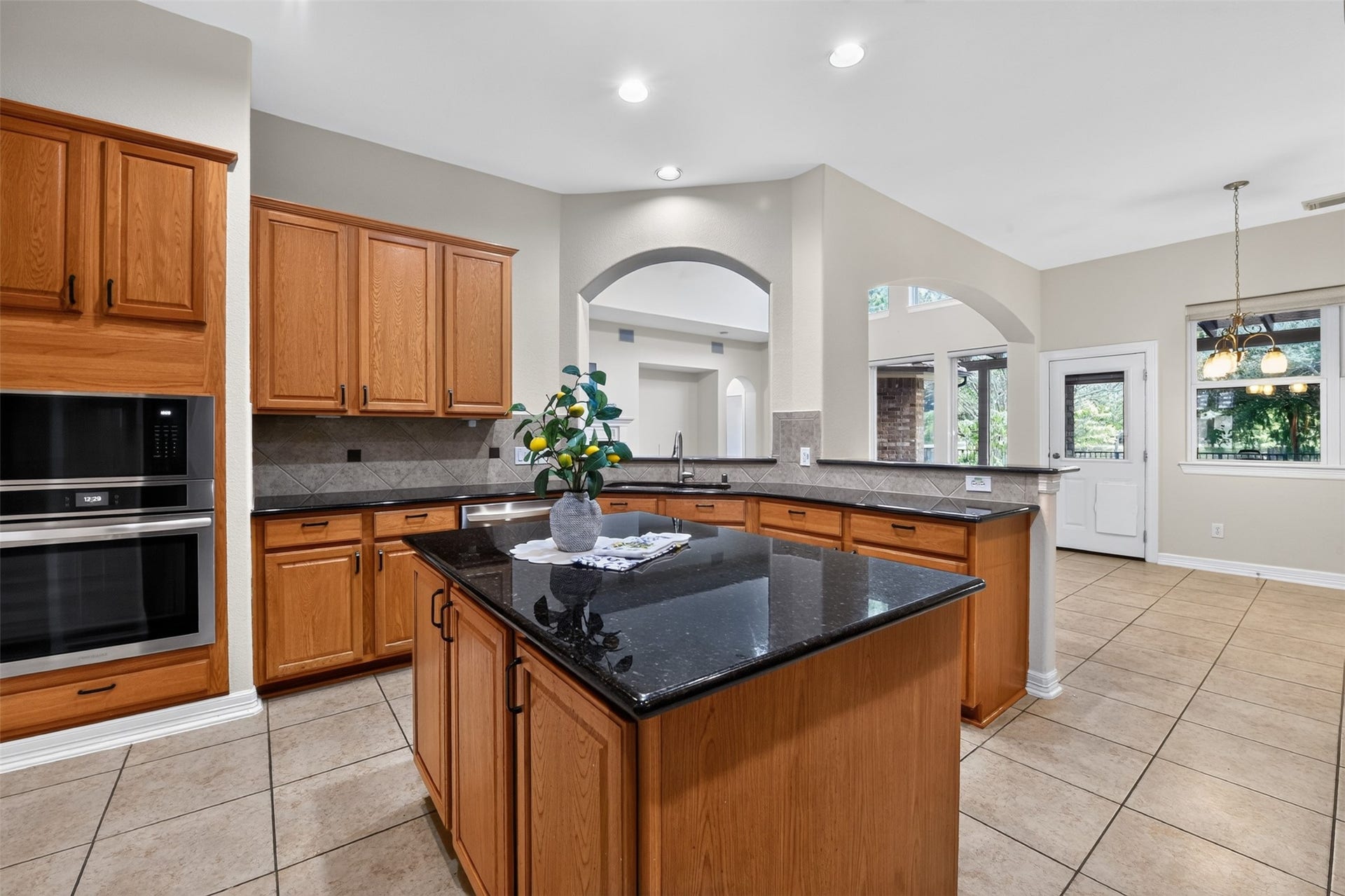 12009 Cedar Creek Drive, Pearland, TX 77584 There is also a center island - convenient with storage cabinets. Plenty of cabinets throughout this kitchen too!