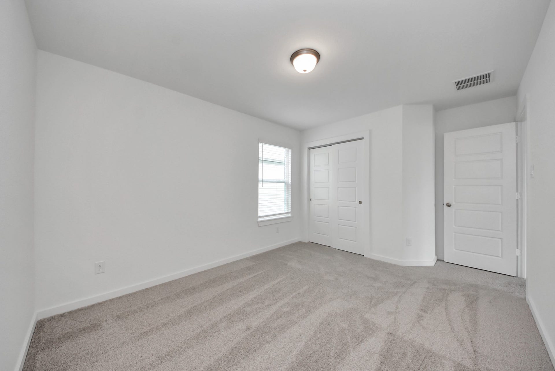 Generously sized secondary bedrooms featuring spacious closets, soft and inviting carpeting underfoot, large windows allowing plenty of natural light, and the added touch of privacy blinds for your personal retreat.