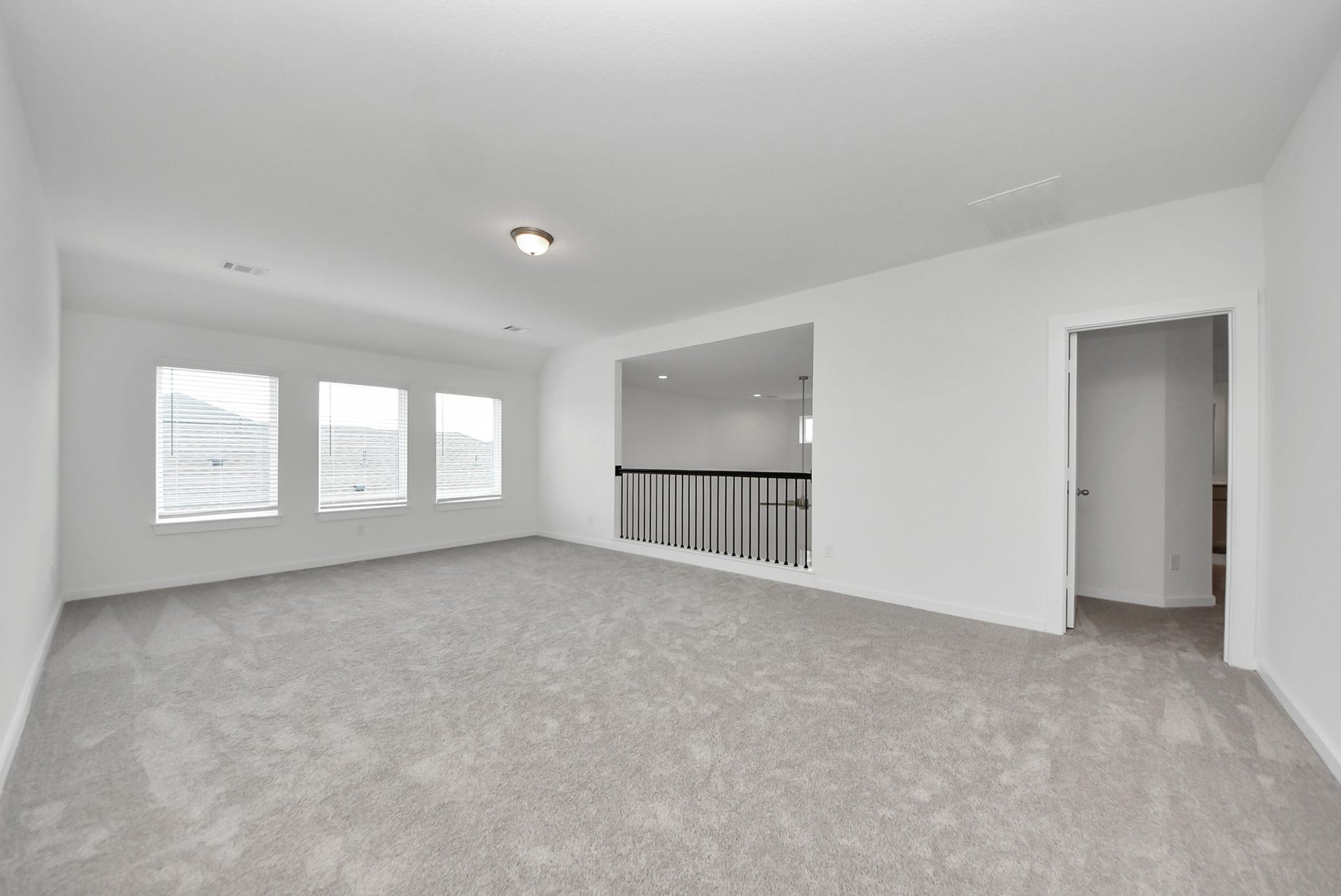 Come upstairs and enjoy a day of leisure in this fabulous game room! This is the perfect hangout spot or adult game room! Features plush carpet, high ceilings, custom paint and windows for plenty of natural light.