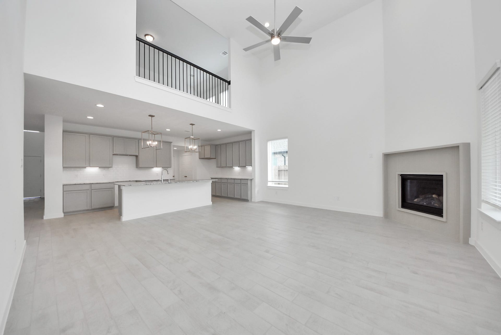 Embrace the warmth and comfort of this inviting family room, flooded with natural light that showcases breathtaking views of the community lake through expansive windows. The premium tile flooring adds a touch of luxury to the space, creating the perfect setting for relaxing moments and cherished gatherings with loved ones