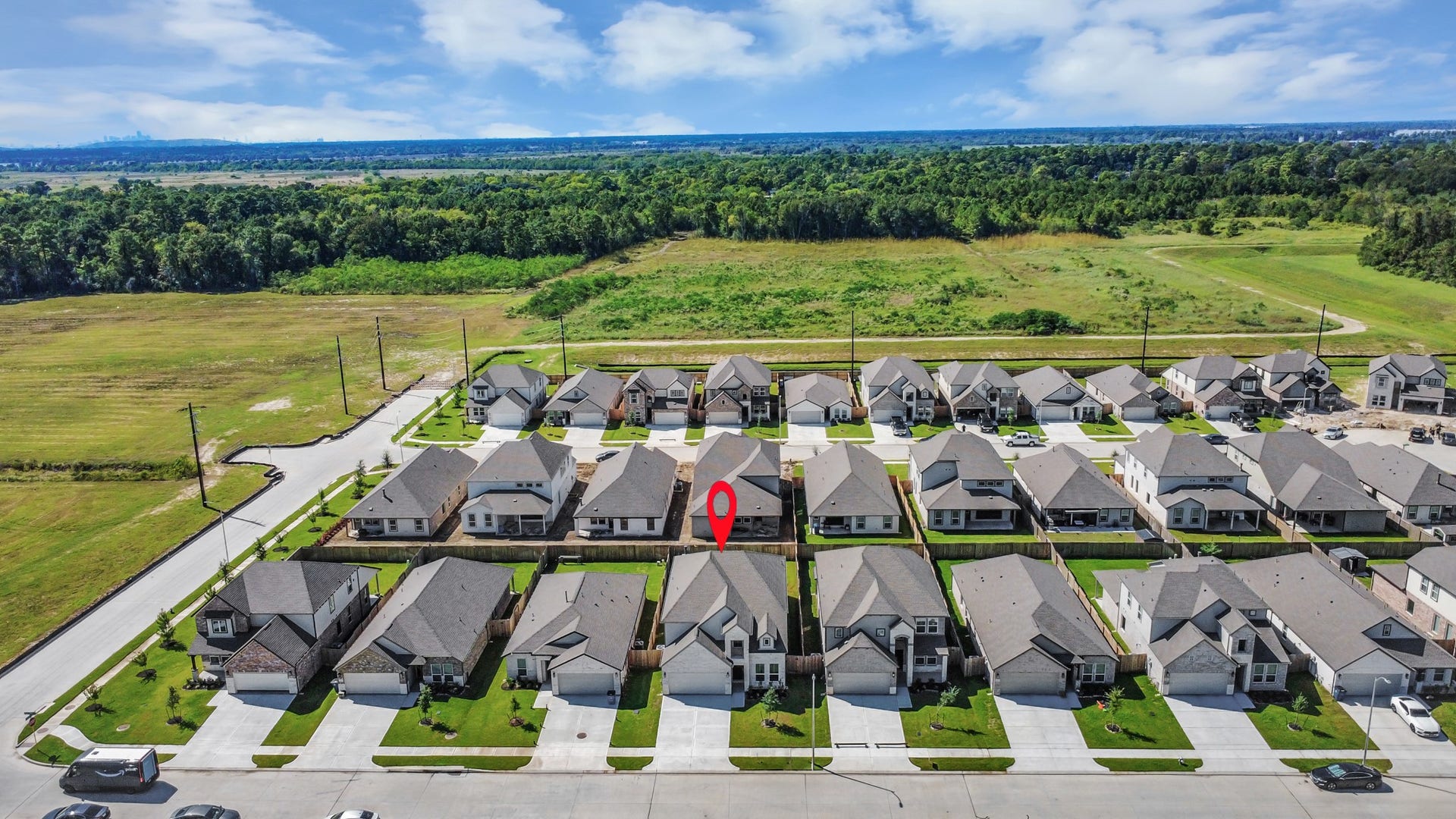An aerial view of a spacious subdivision lot, highlighting a well-maintained yard and a fully fenced perimeter, offering both privacy and expansive outdoor space.