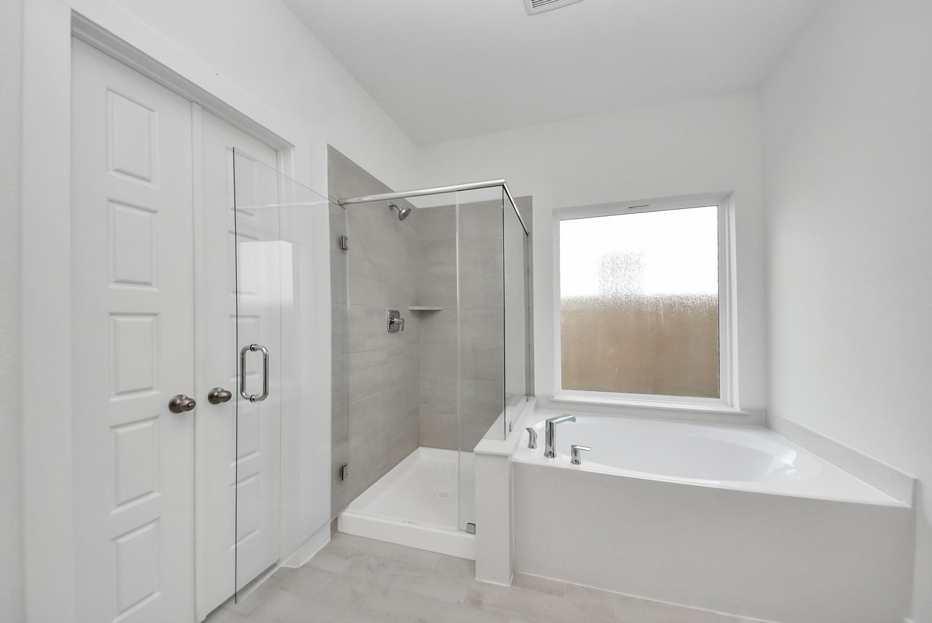 Indulge in a spa-like retreat within the confines of this primary bathroom. Delight in a spacious walk-in shower enveloped in stylish tile surround, unwind in a separate garden tub adorned with custom detailing.