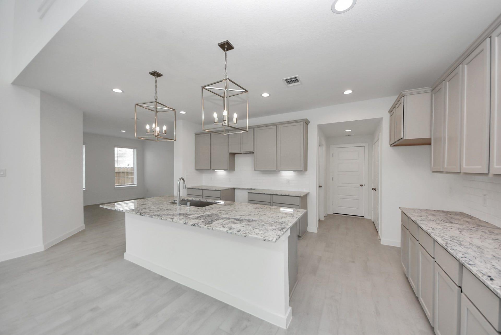 The kitchen is a culinary haven, featuring granite countertops, a tile backsplash, stainless steel appliances, 42 upper cabinets, and undercabinet lighting.
