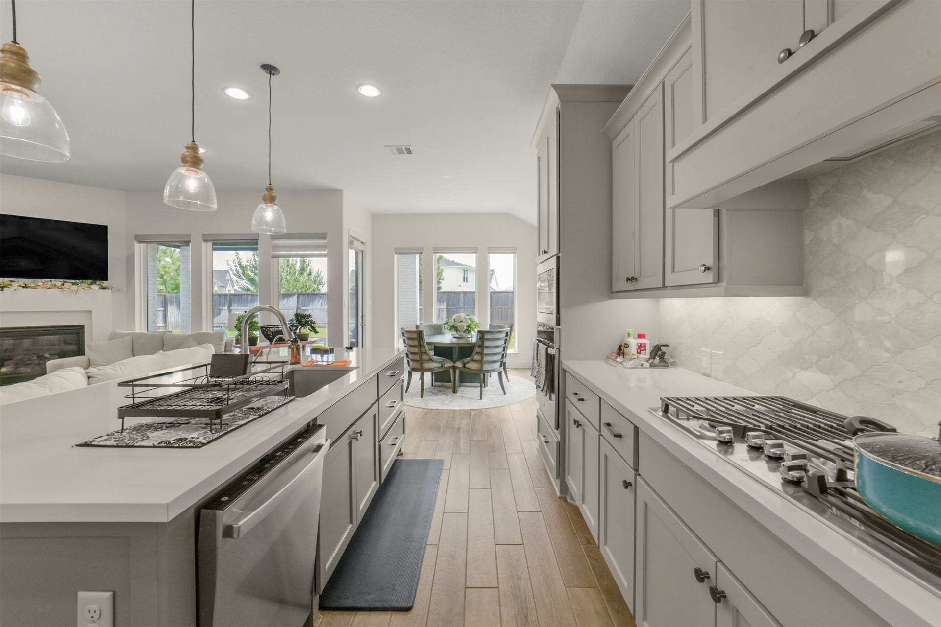 1910 Longcroft Lane, Katy, TX 77493 Pendant lighting and designer finishes elevate this beautiful gathering space.