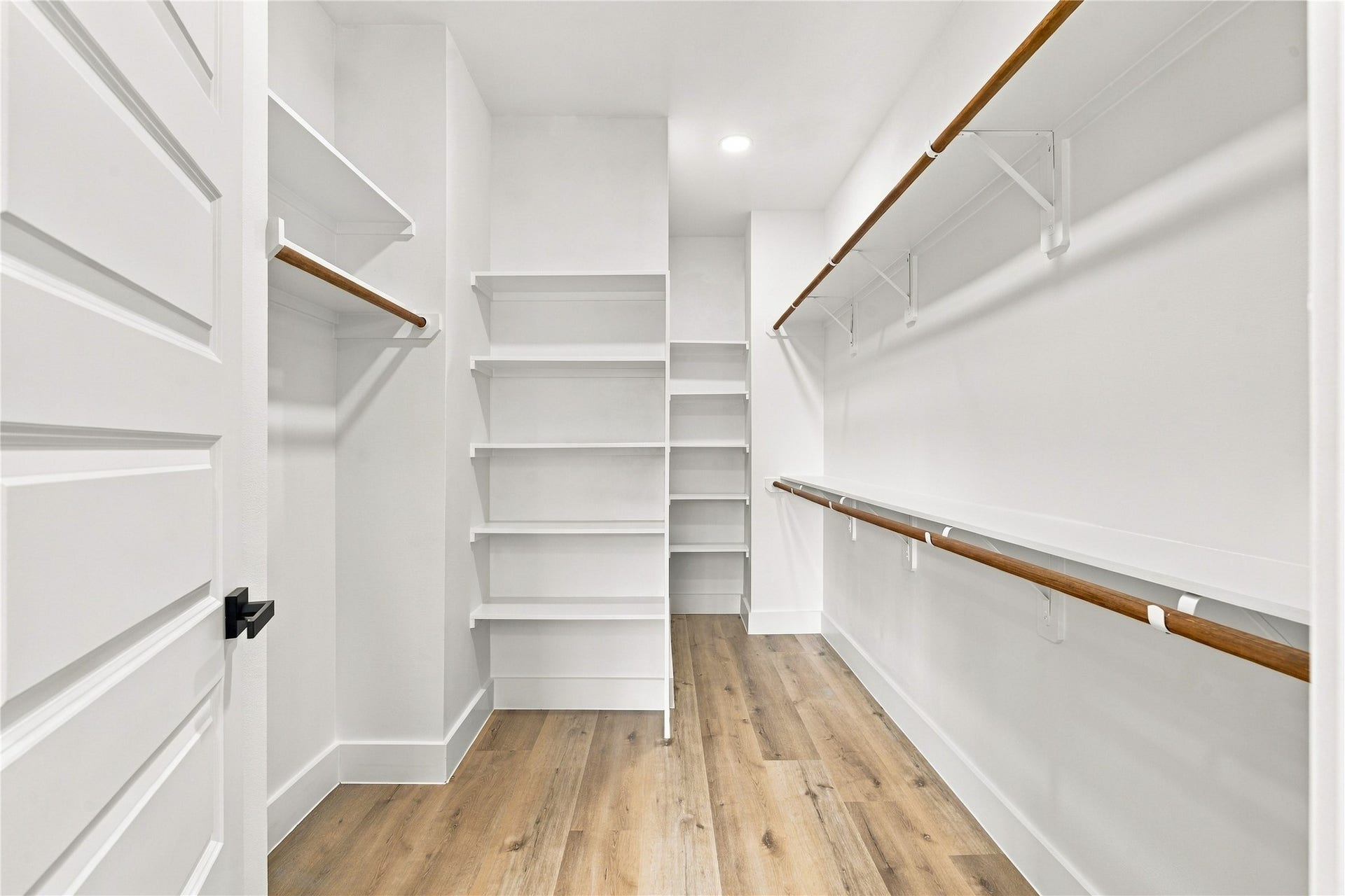4717 Branch Street, Houston, TX 77021 Custom walk-in closet extensive multi-level hanging rods and shoe shelving tailored for maximum organization.