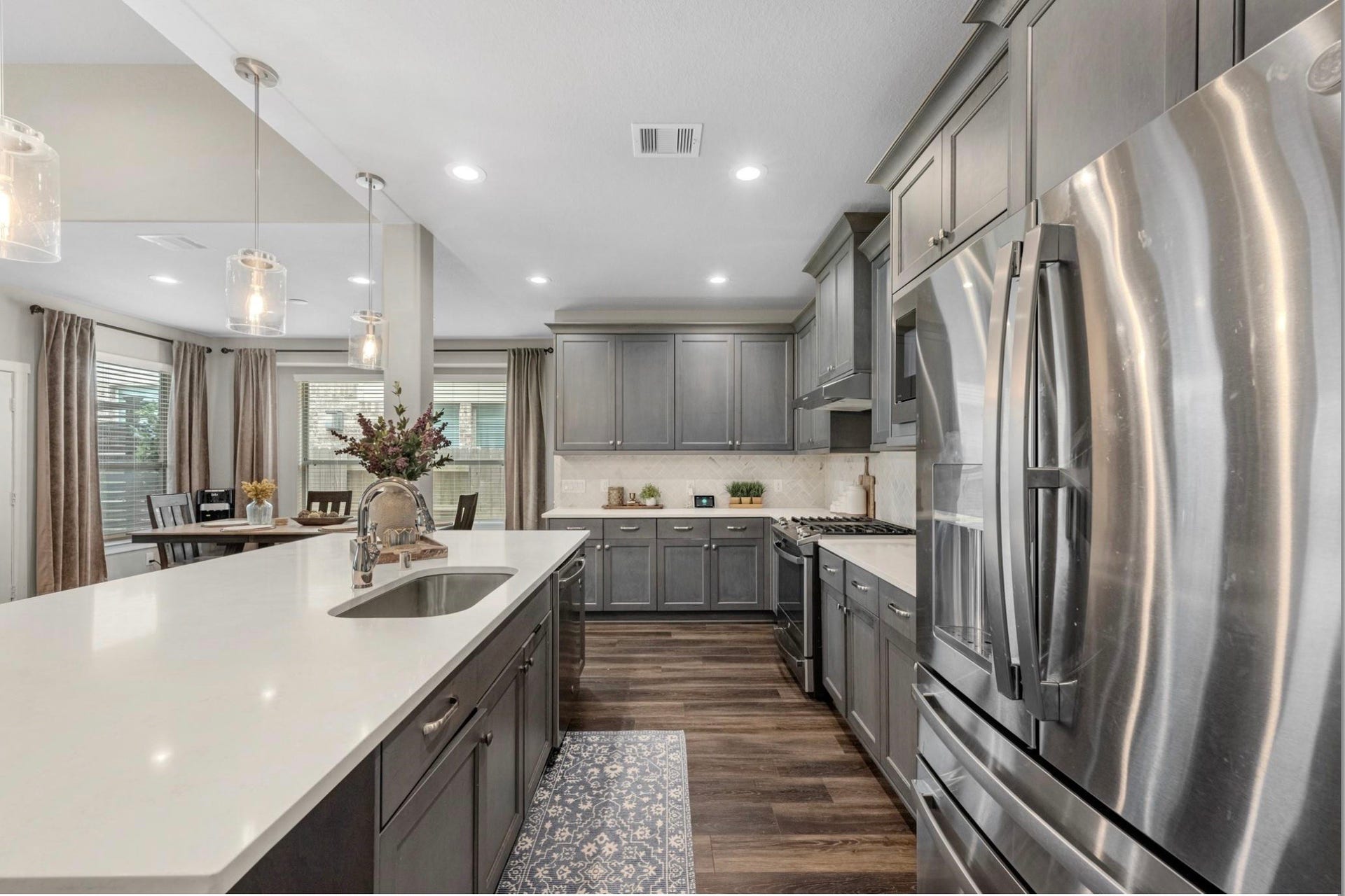 Well-appointed kitchen with stainless steel appliances, gas cooktop, generous counter space, and a functional layout that opens seamlessly to the main living areas.