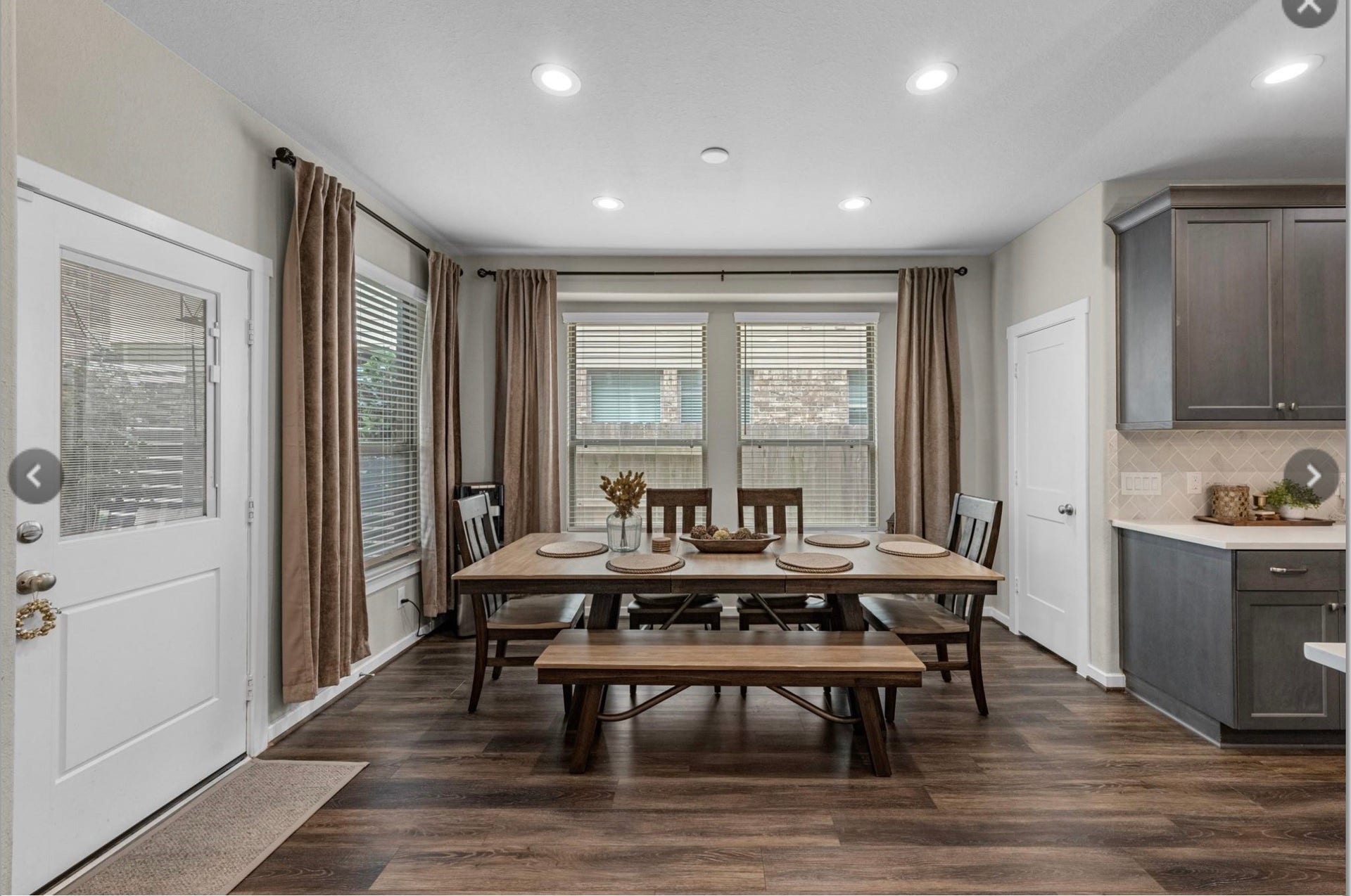 Elegant dining space with large windows that fill the room with natural light.