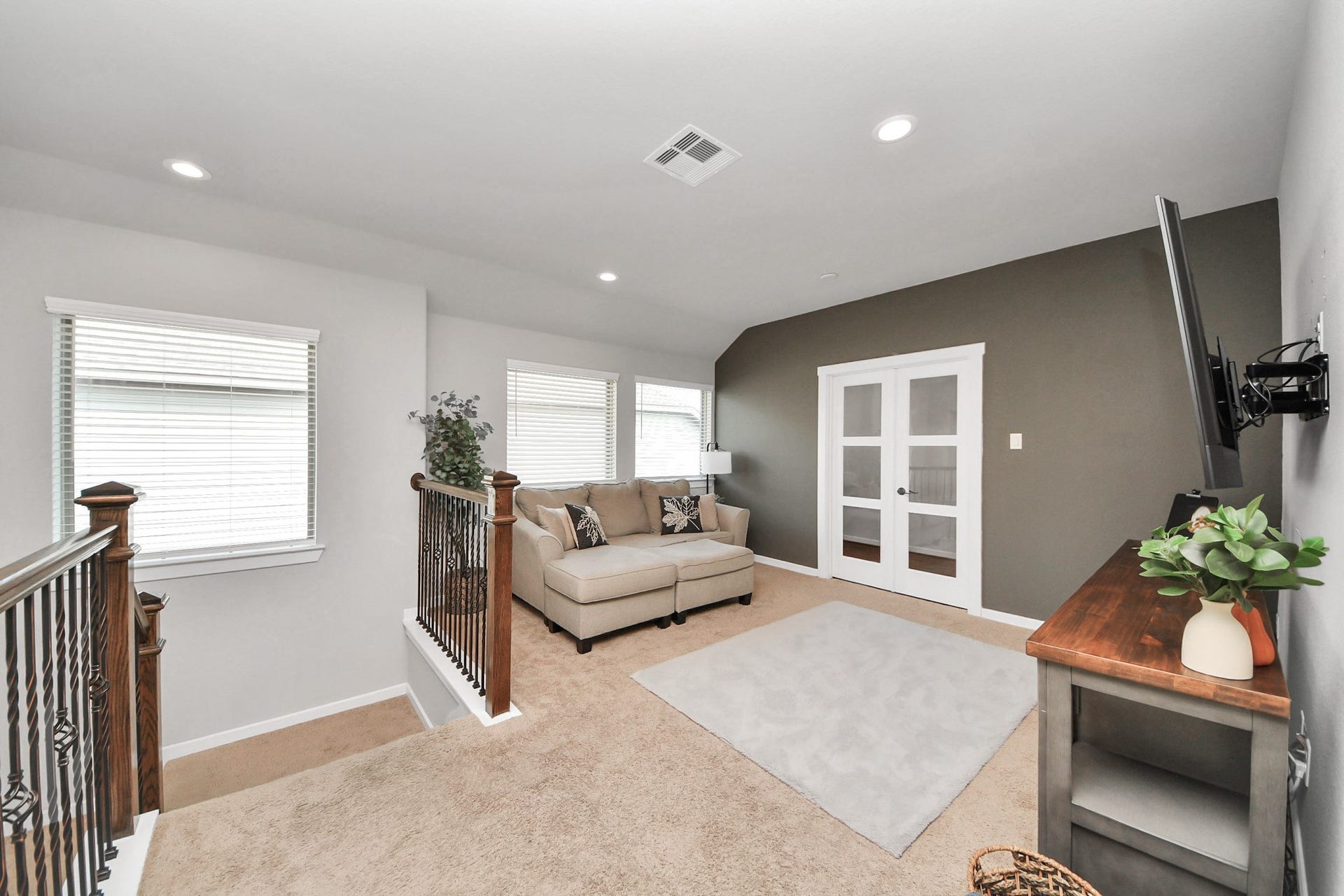 Spacious upstairs game room offering a versatile second living area with recessed lighting, neutral finishes, and room for entertainment or relaxation.