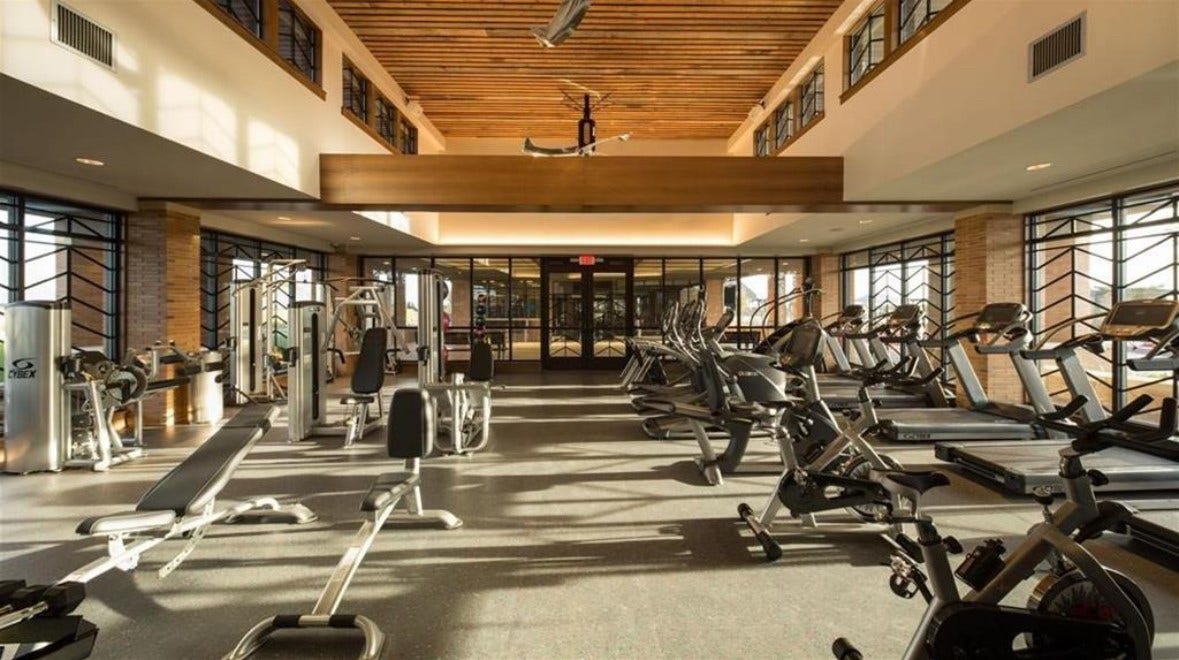 Elyson residents enjoy access to a well-equipped fitness center featuring cardio equipment, strength-training machines, and dedicated workout areas.