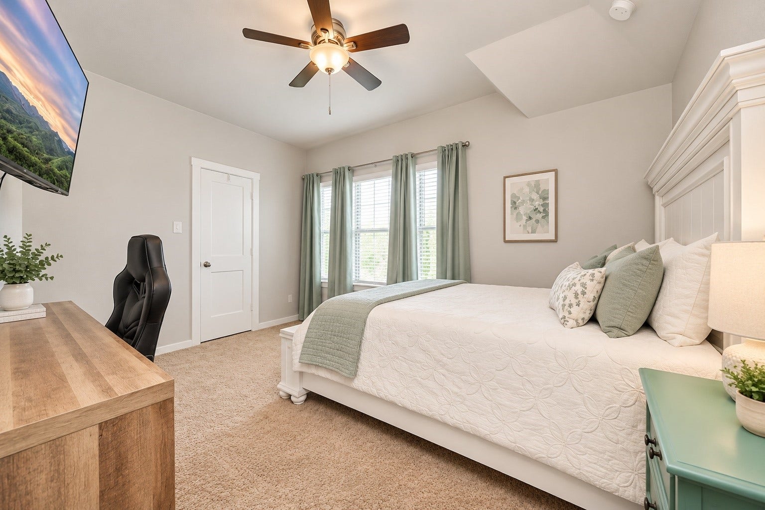 Bright secondary bedroom featuring a high ceiling, ceiling fan, neutral finishes, and ample space for bedroom furniture.