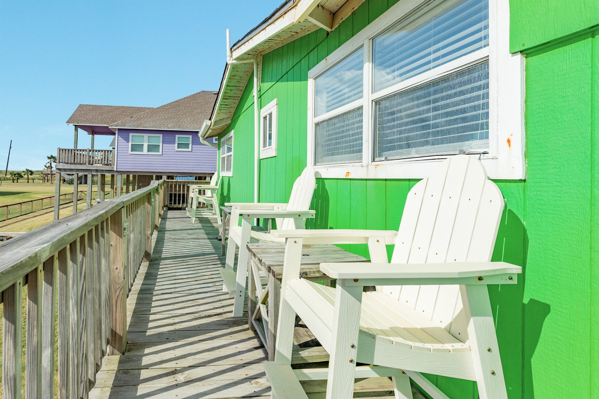 Adirondack-style seating lines the exterior deck, creating a casual spot to enjoy the open surroundings.