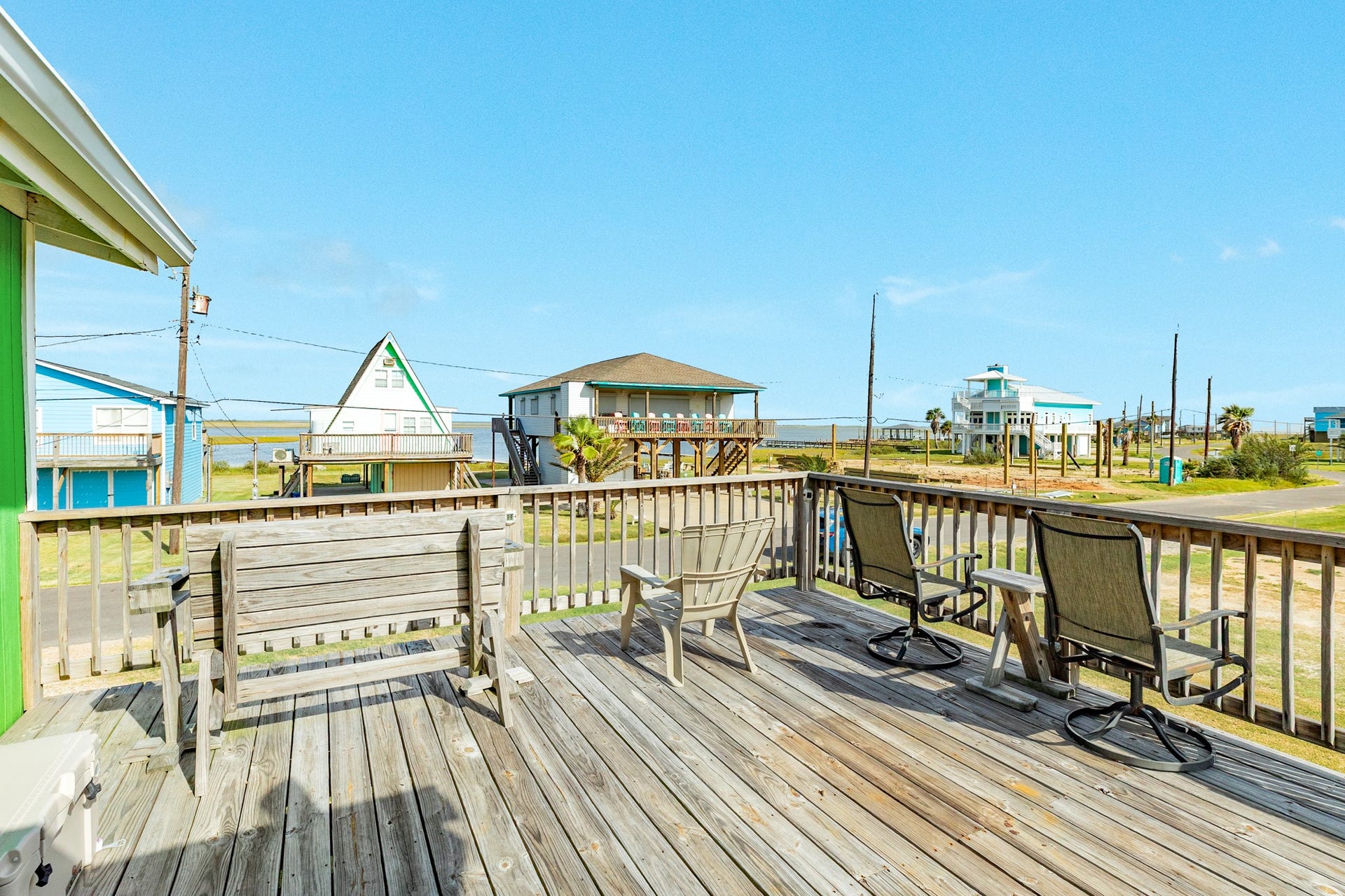 Open-air deck provides a comfortable setting for relaxing outdoors, with neighborhood and water views beyond the railing.