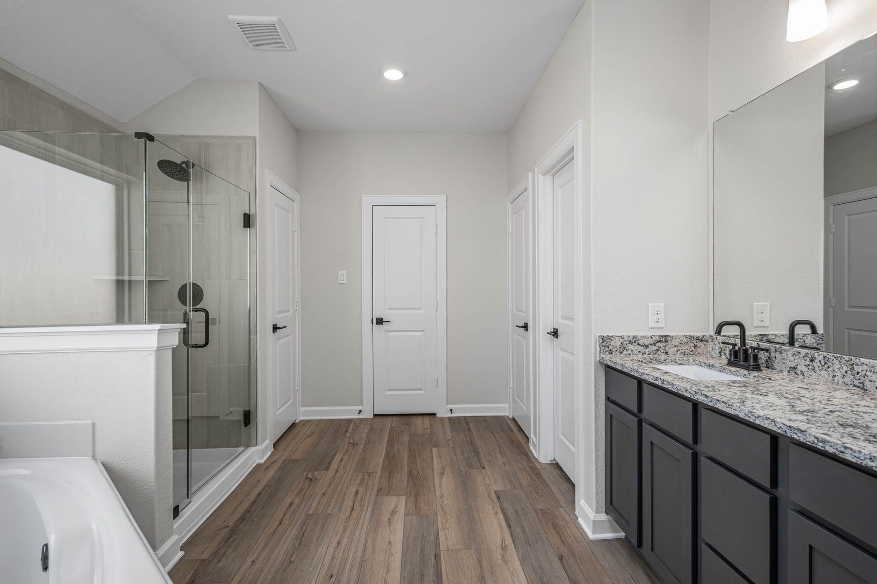 14002 Starboard Reach Drive, Texas City, TX 77510 The primary bathroom features corner soaking tube, tiled walk in shower, and double closets