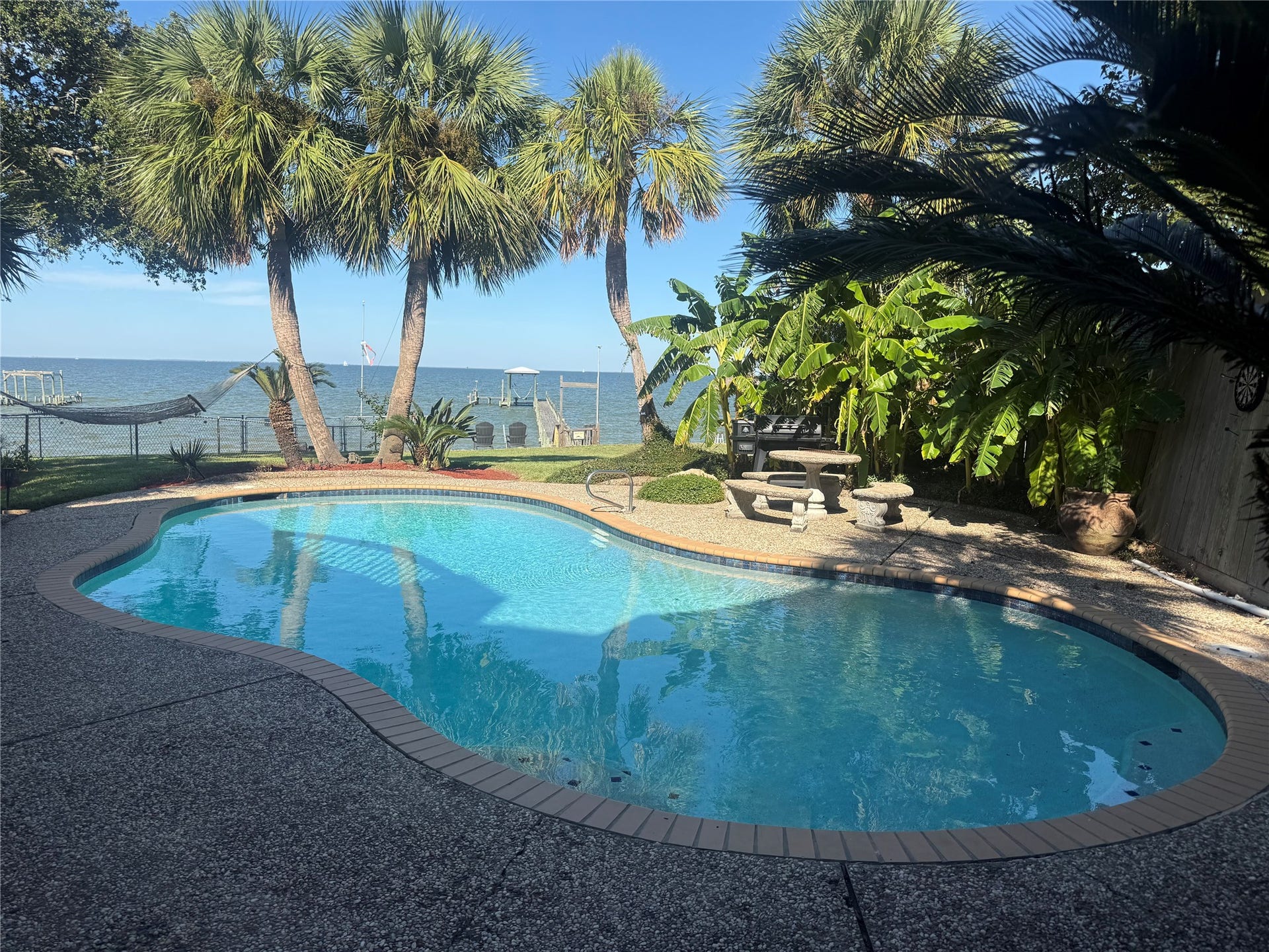 4715 W Bayshore Drive, Bacliff, TX 77518 The waterfront view from the pool is amazing.